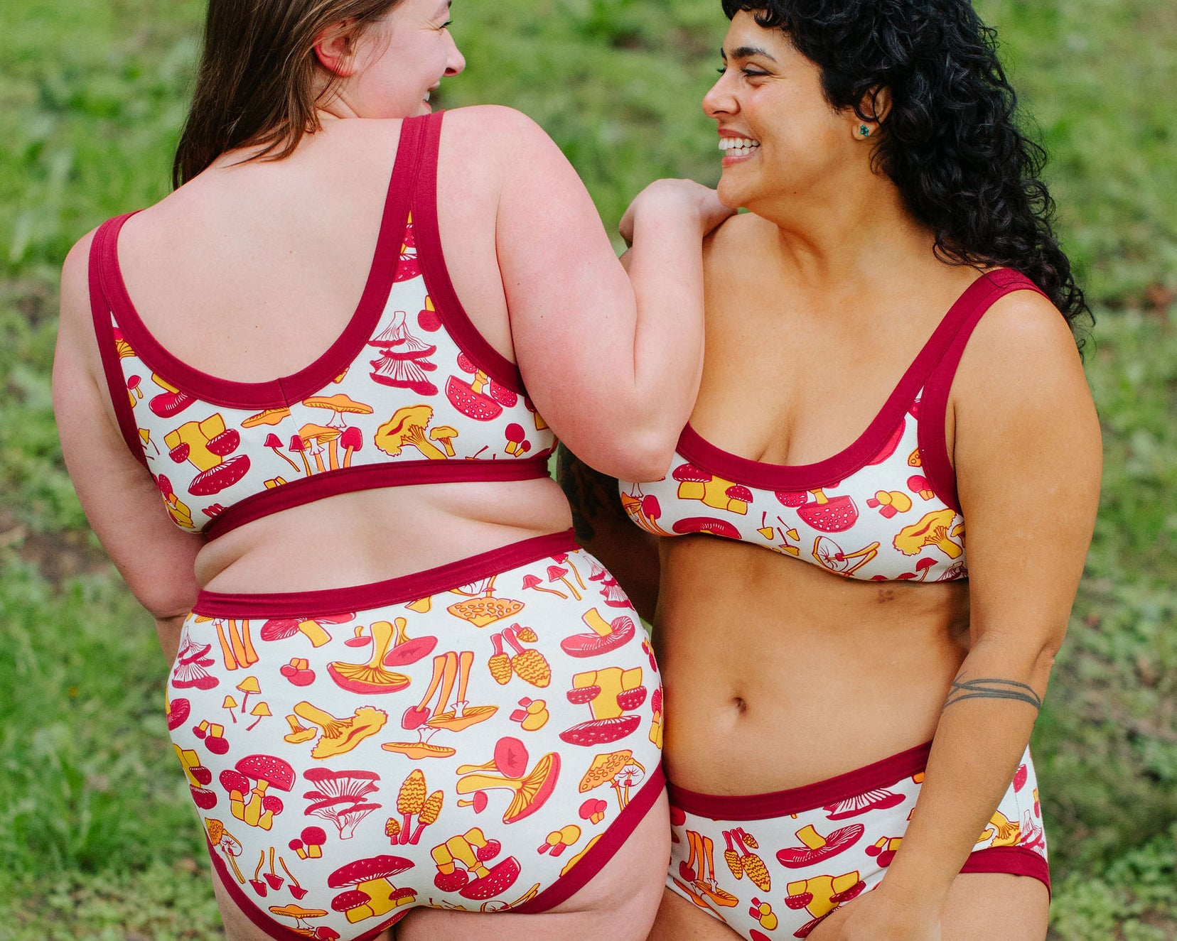 Two models wearing Thunderpants Bralette and underwear in Whadda Fungi print - red, yellow, and orange mushroom print.