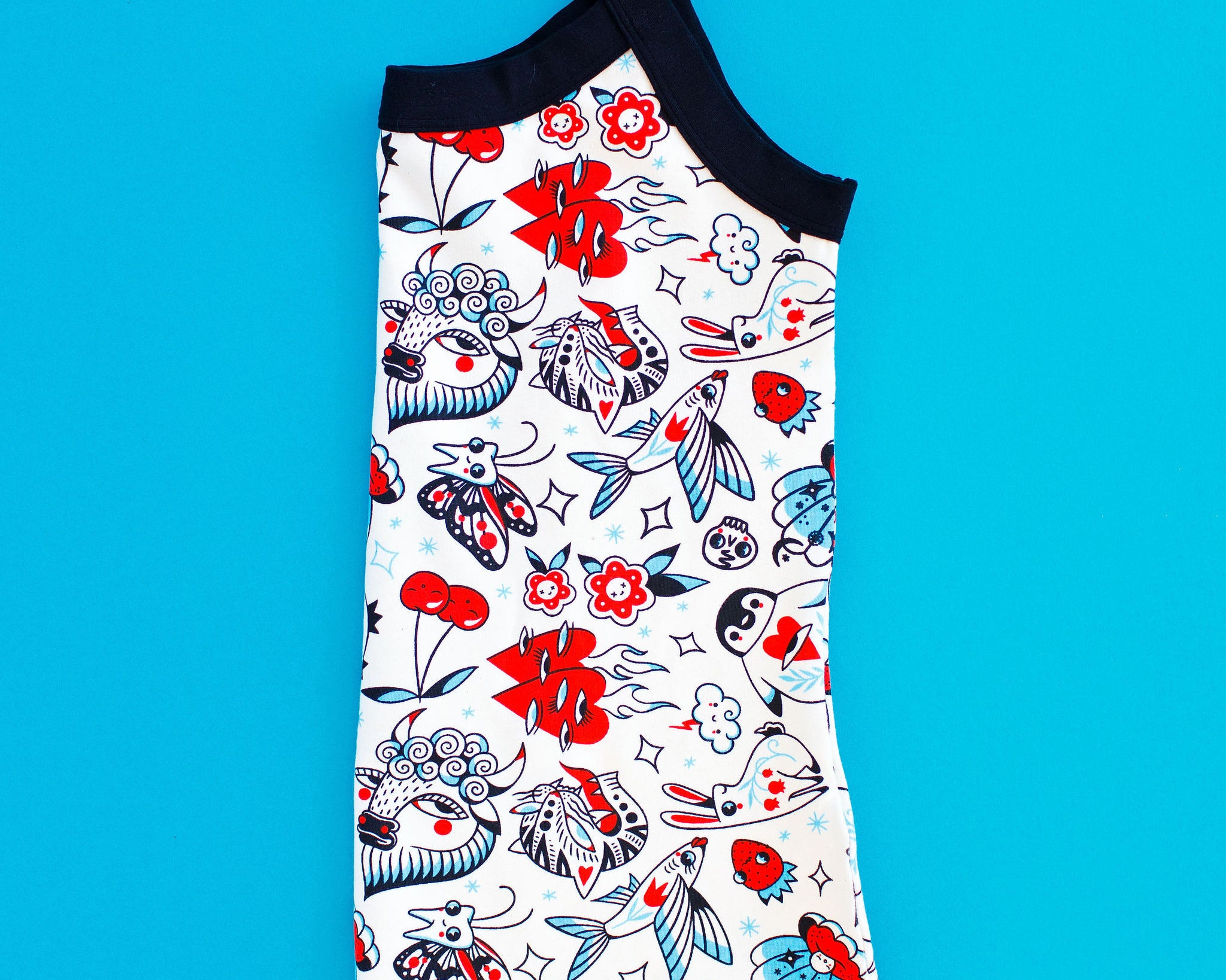 Flat lay of folded Thunderpants Cami in Inked Up print - black, blue, and red tattoos.