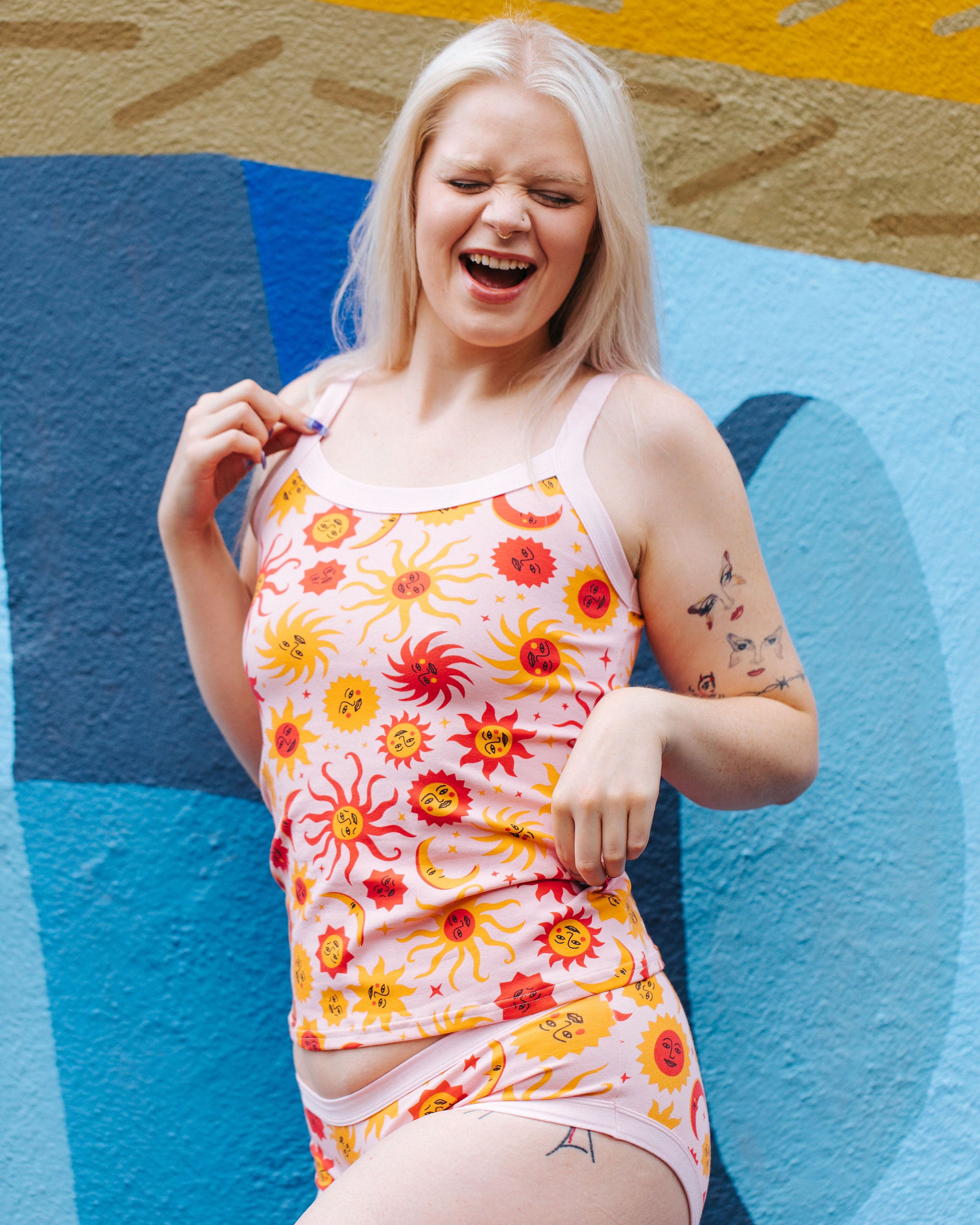 Model wearing Thunderpants Cami and Hipster style underwear in Luna y Sol print - pink, yellow, and orange suns and moons.