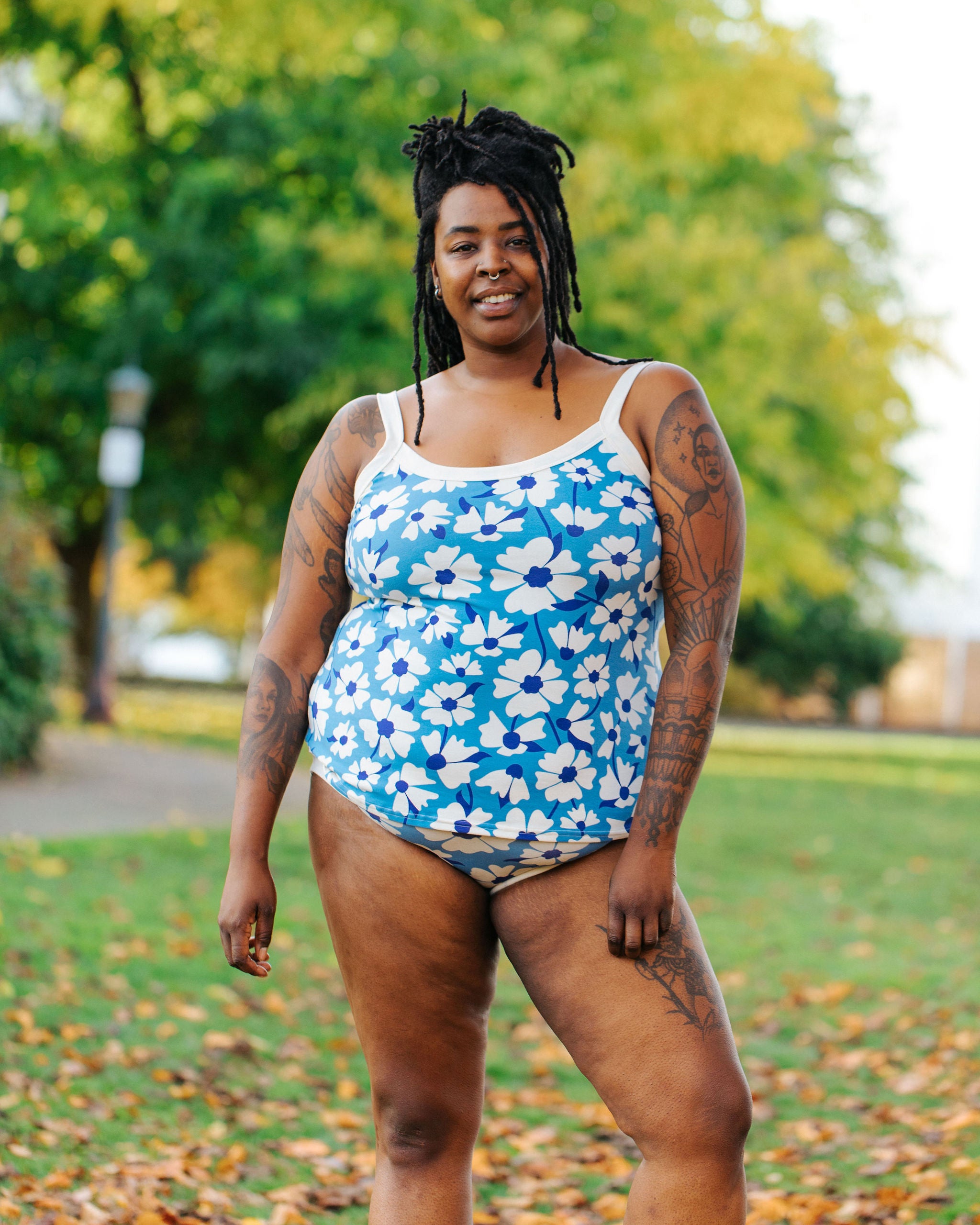 Model wearing Thunderpants Camisole  and Hipster style underwear in Moody Blooms - white and blue flowers with blue background.