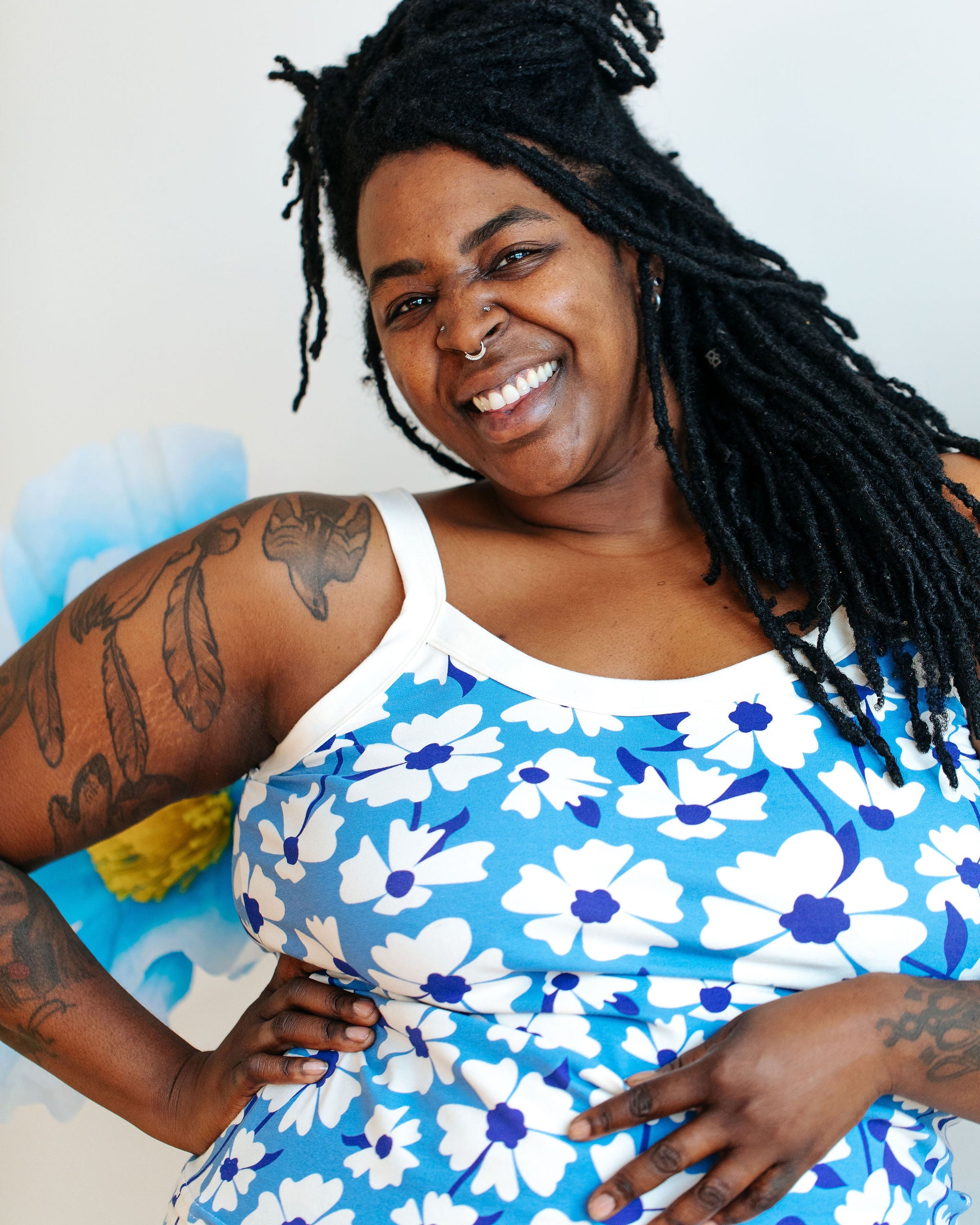 Model wearing Thunderpants Camisole in Moody Blooms - white and blue flowers with blue background.
