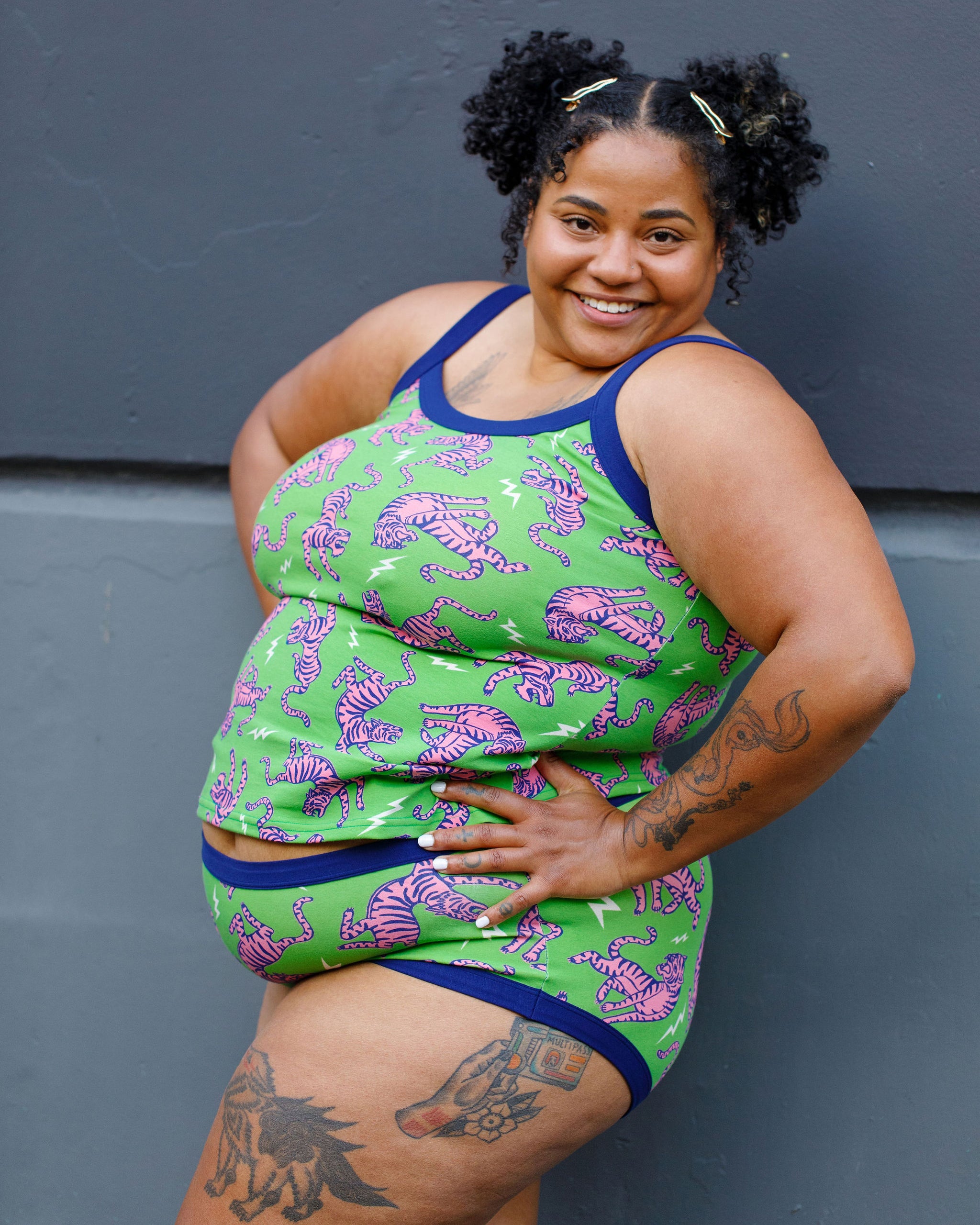 Model wearing Thunderpants organic cotton Cami and Hipster style underwear in Electric Tiger - green with pink and blue tigers and white lightning bolts.