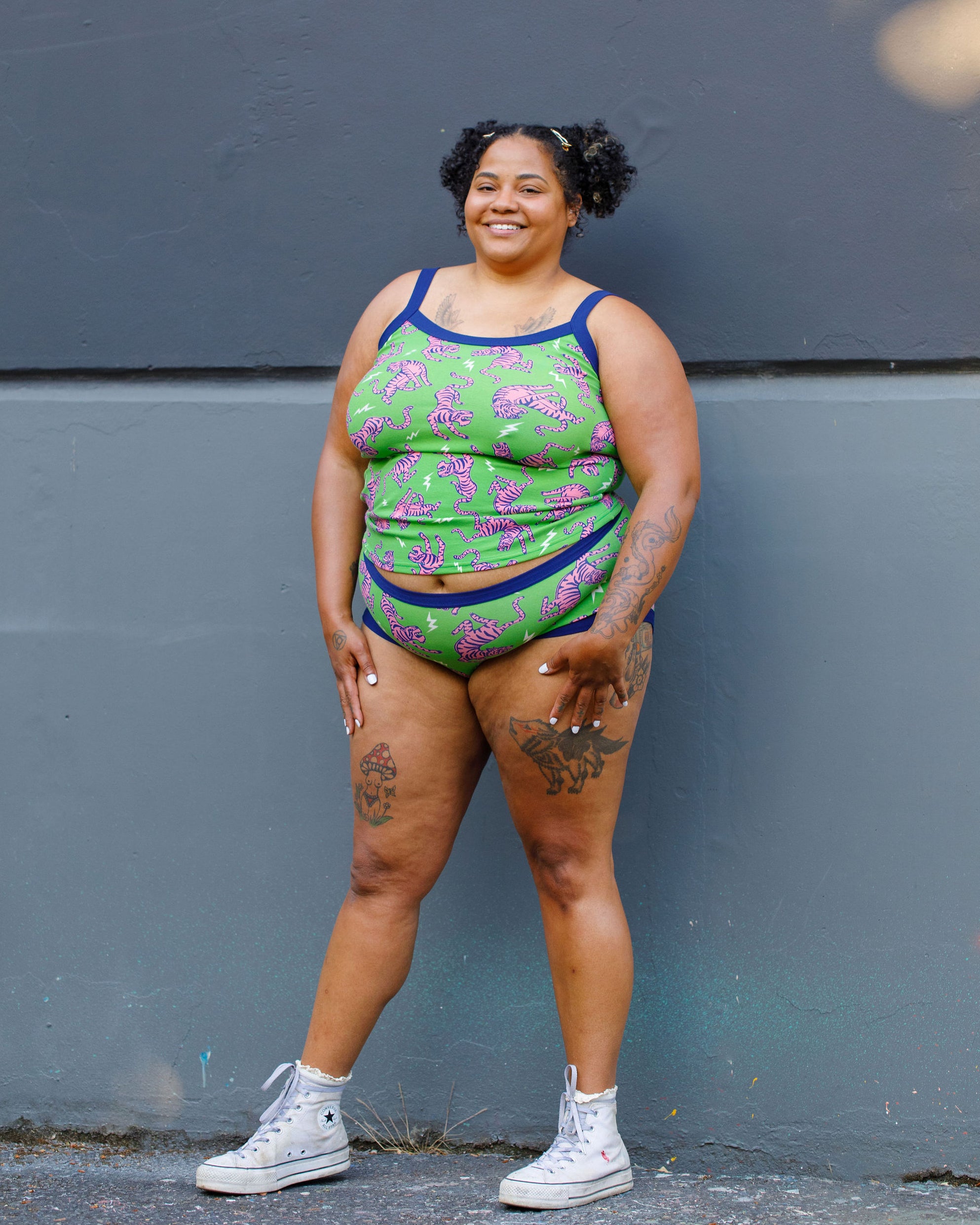 Model wearing Thunderpants organic cotton Cami and Hipster style underwear in Electric Tiger - green with pink and blue tigers and white lightning bolts.