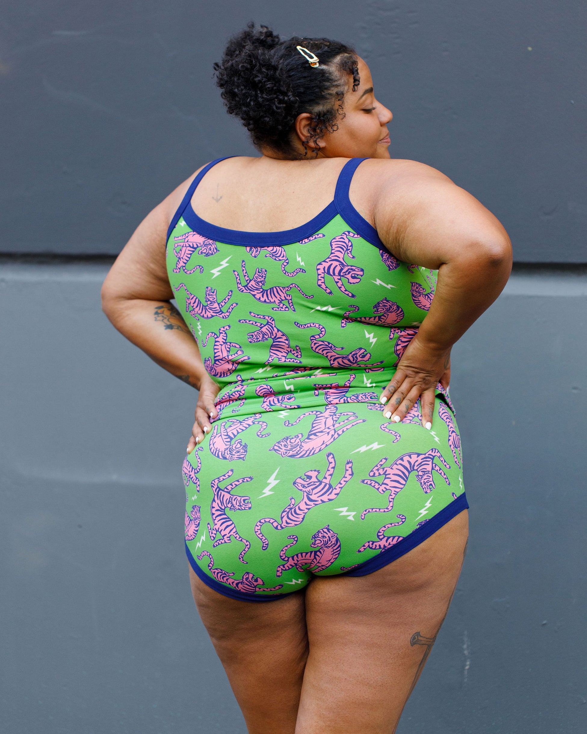 Model wearing Thunderpants organic cotton Cami and Hipster style underwear in Electric Tiger - green with pink and blue tigers and white lightning bolts.