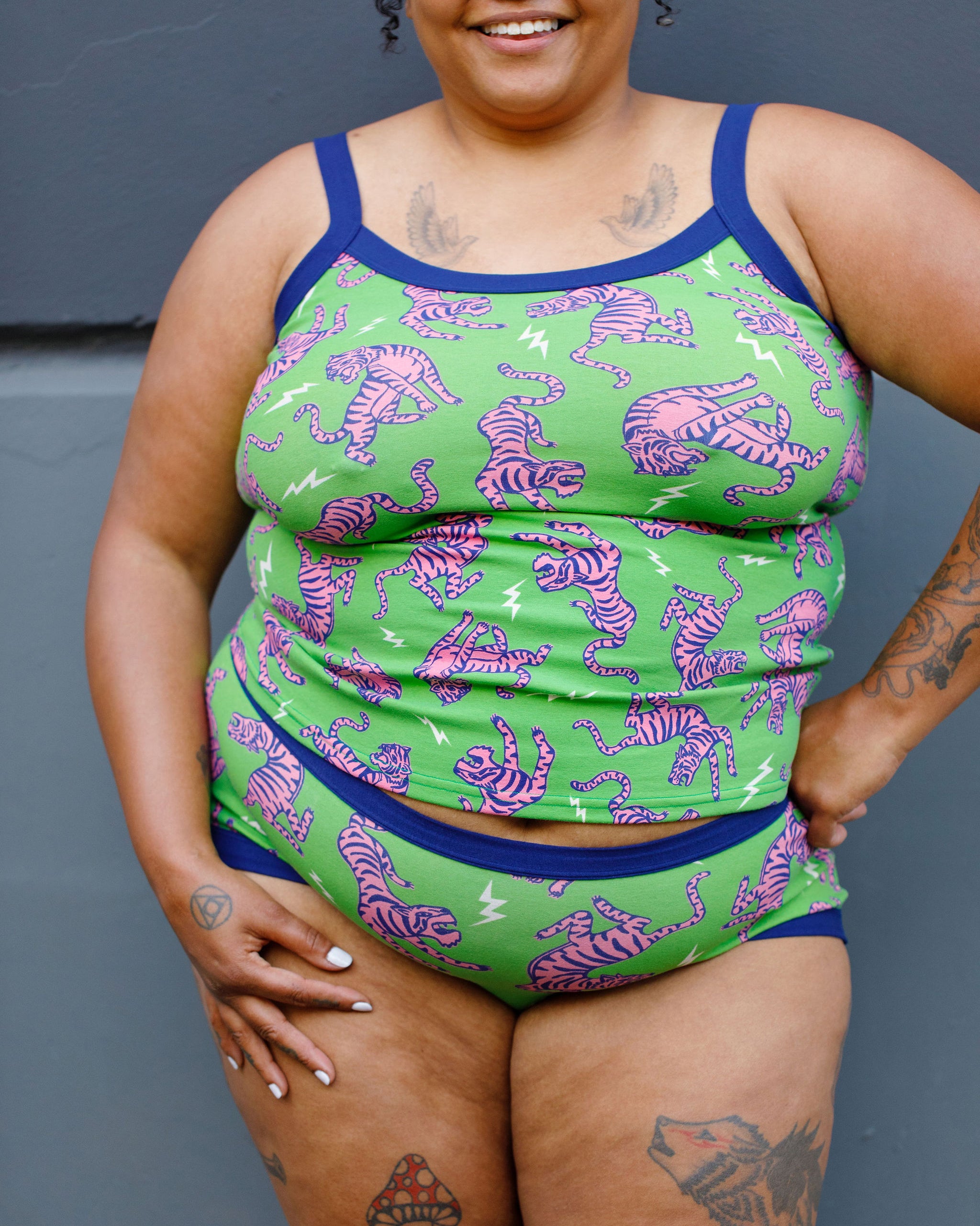 Model wearing Thunderpants organic cotton Cami and Hipster style underwear in Electric Tiger - green with pink and blue tigers and white lightning bolts.