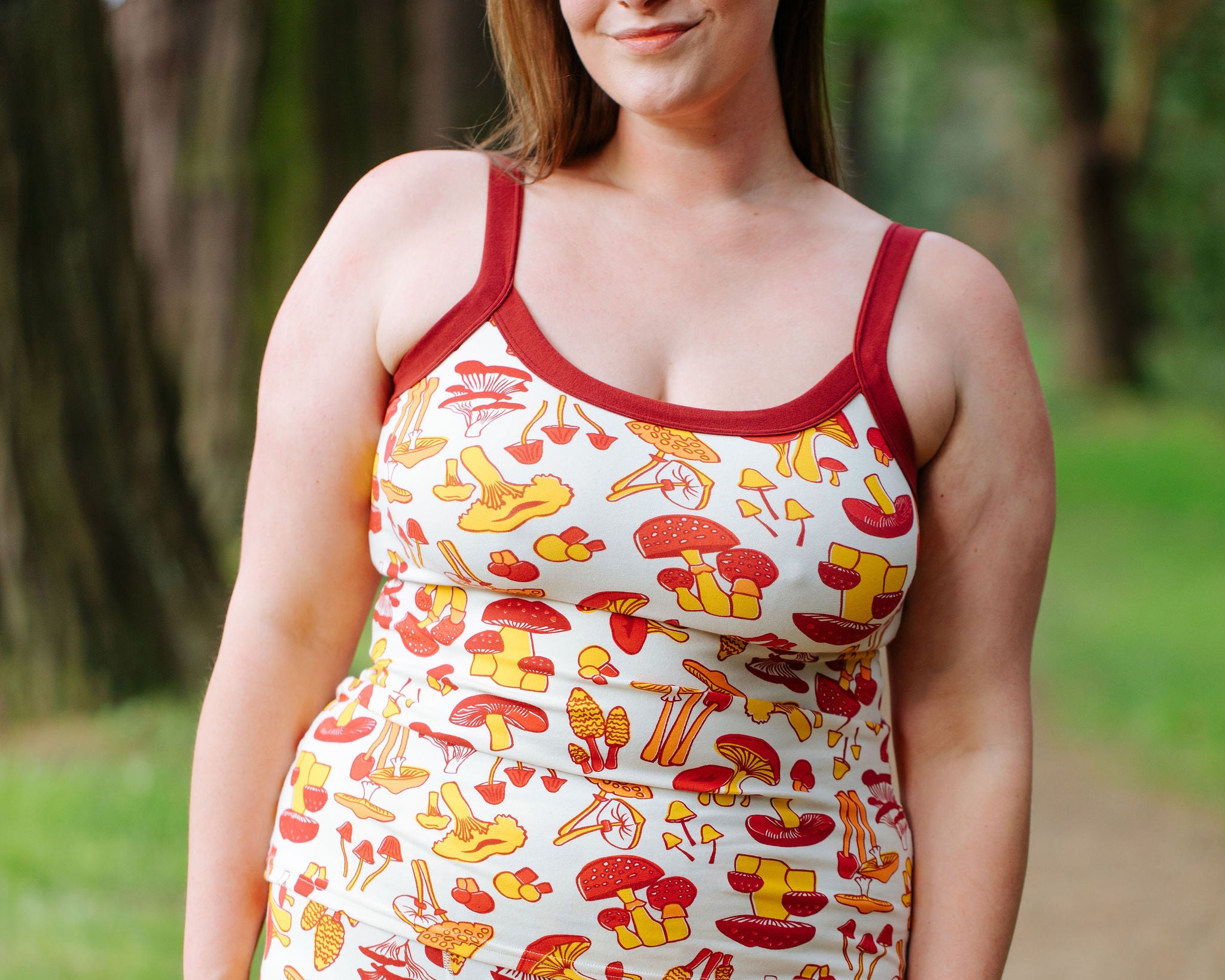 Model wearing Thunderpants Cami and Boxer Brief style underwear in Whadda Fungi - red, yellow, and orange mushroom print.