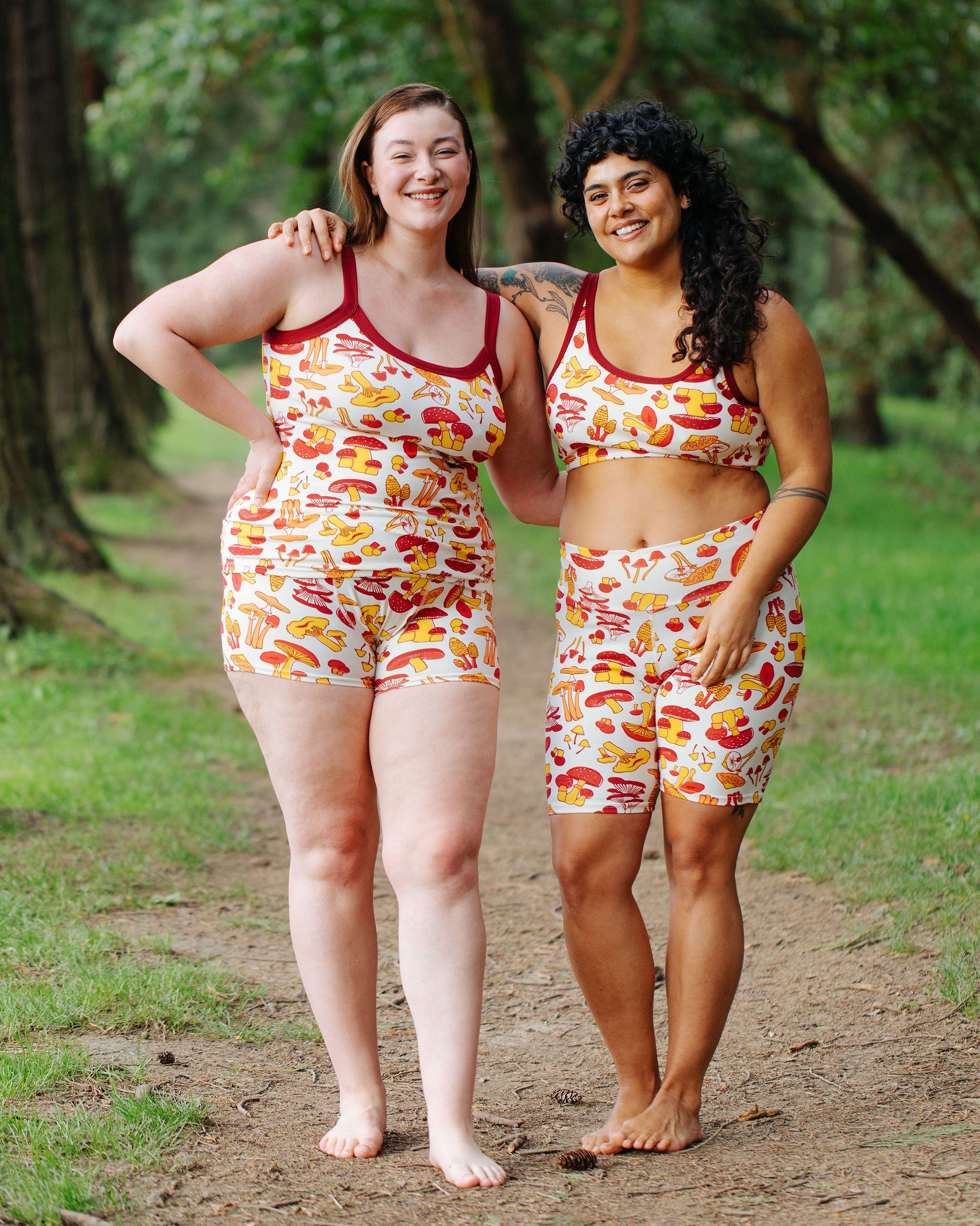 Two models wearing various Thunderpants  items in Whadda Fungi - red, yellow, and orange mushroom print.