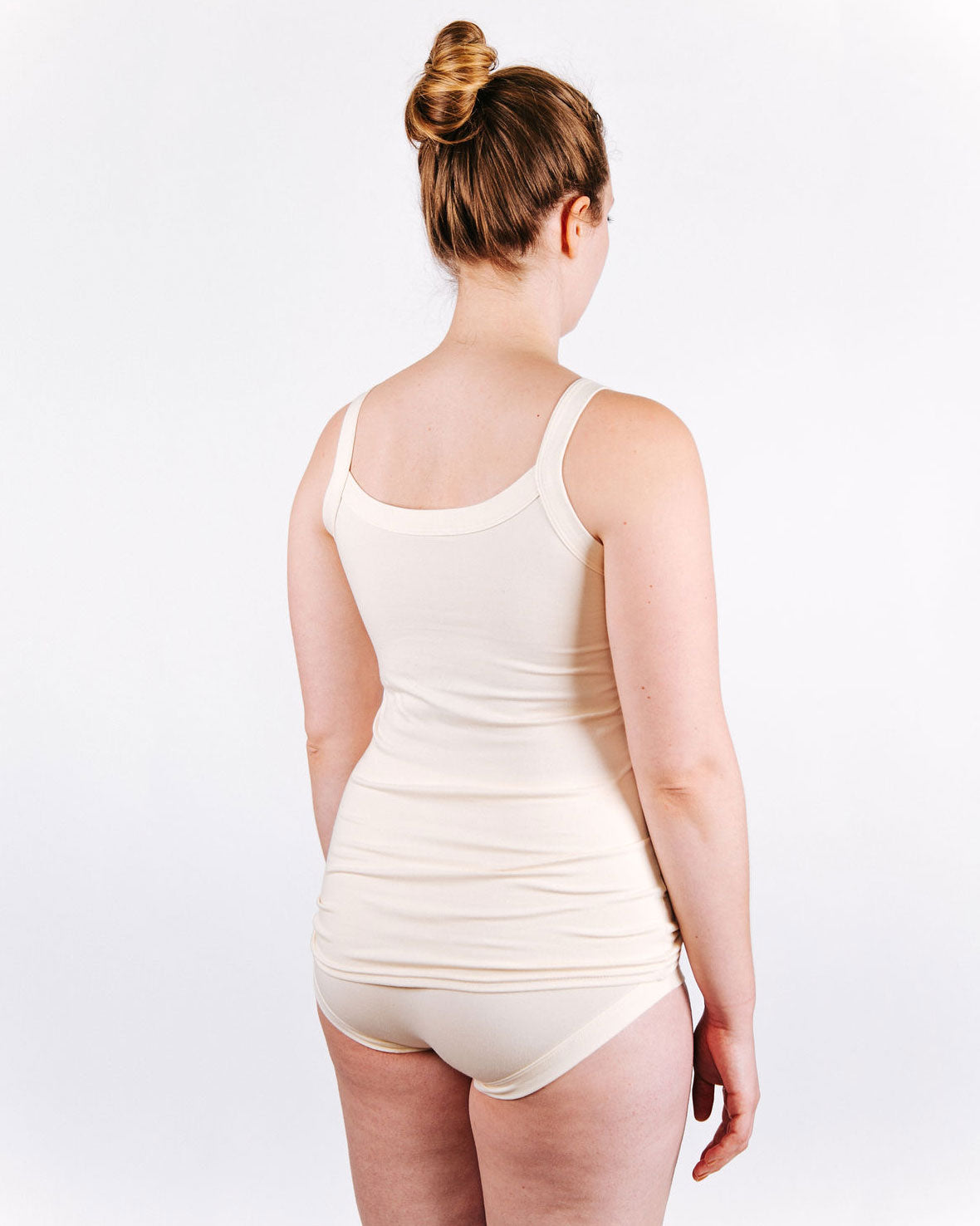 Fit photo from the back of Thunderpants organic cotton Camisole and Hipster style underwear in off-white, showing a wedge-free bum, on a model.