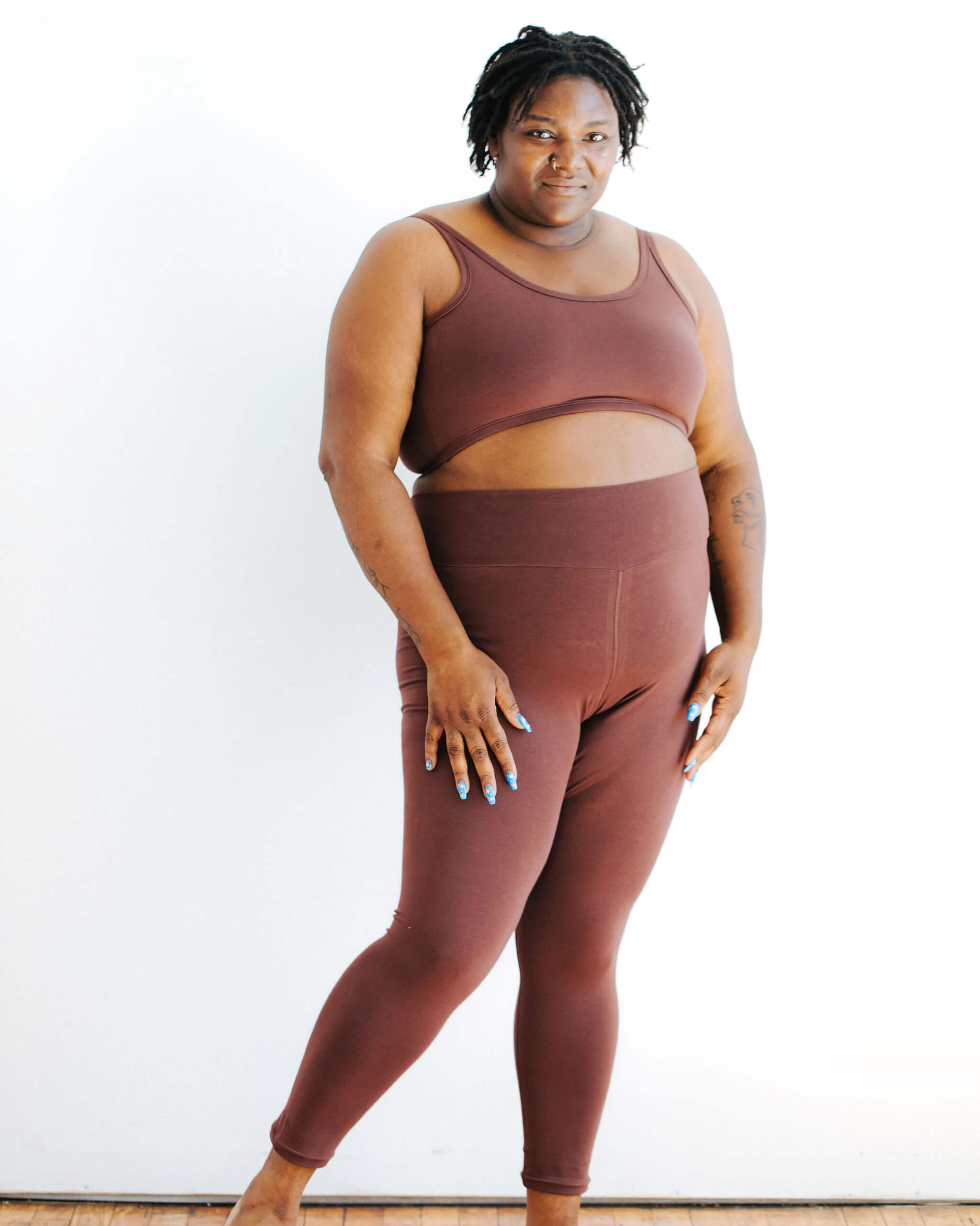 Model wearing Thunderpants Ankle Leggings and Longline Bra in Chestnut - a dark brown color.