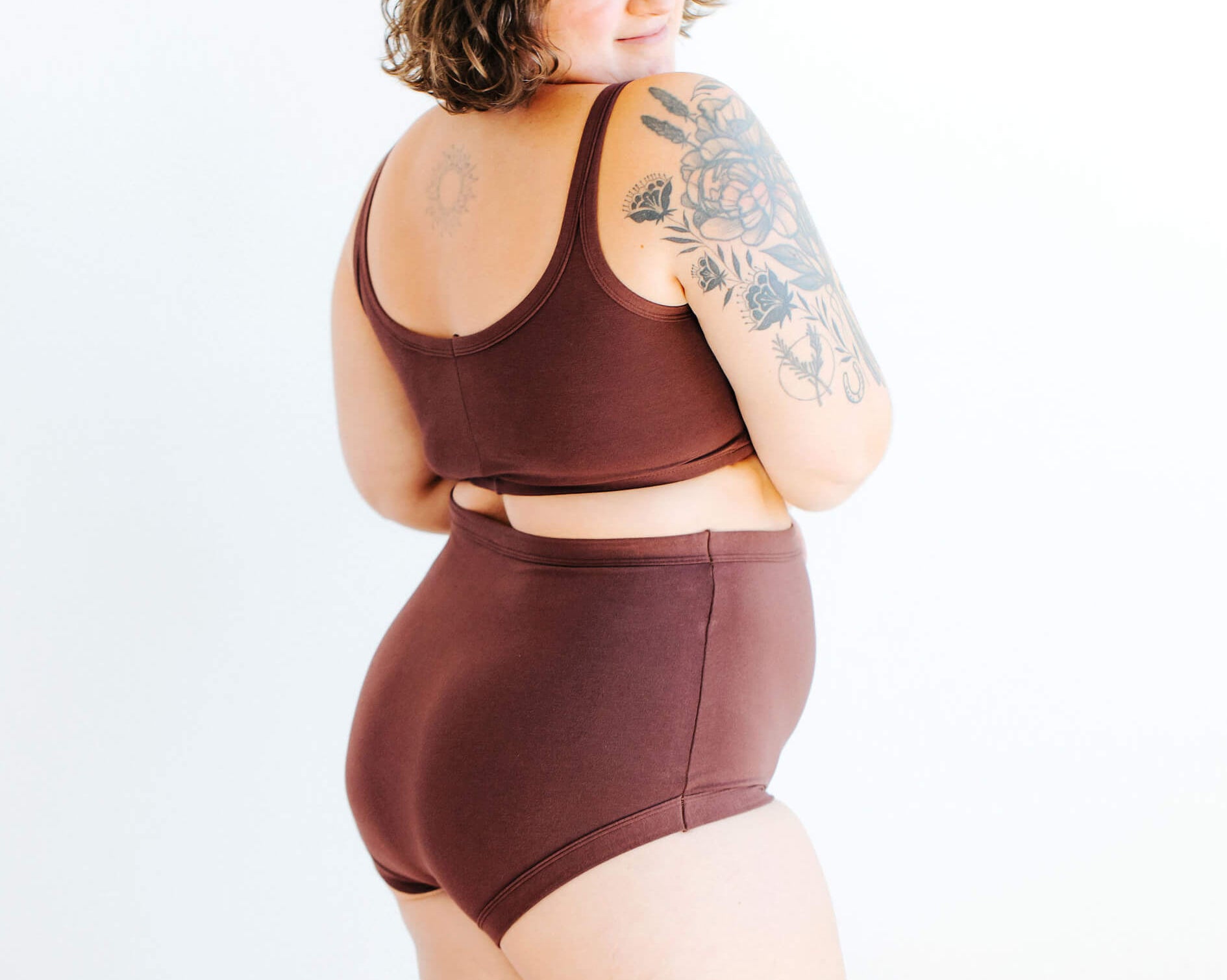 Model wearing Thunderpants Sky Rise style underwear and Longline Bra in Chestnut - a dark brown color.