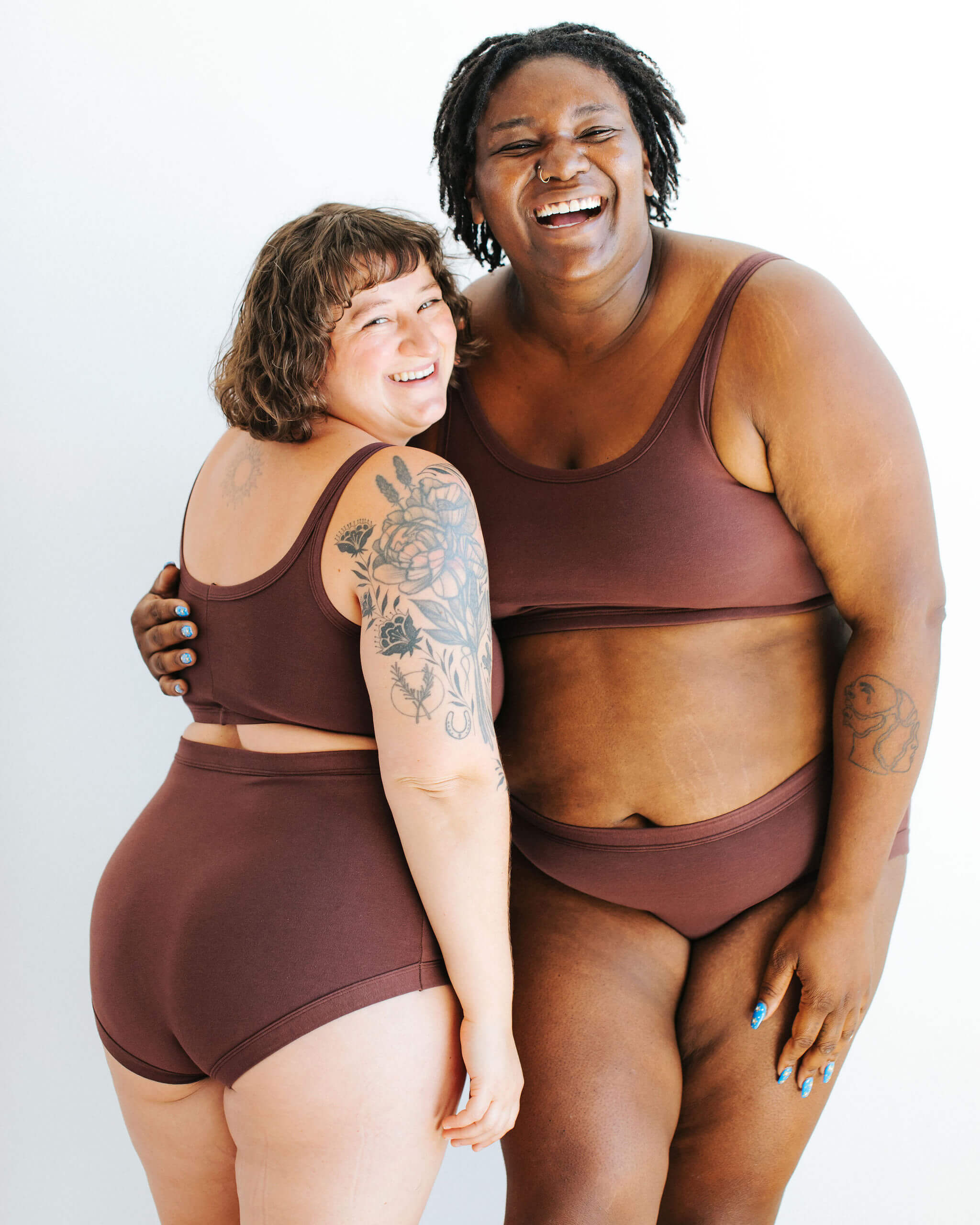 Two models wearing various Thunderpants styles in Chestnut - a dark brown color.