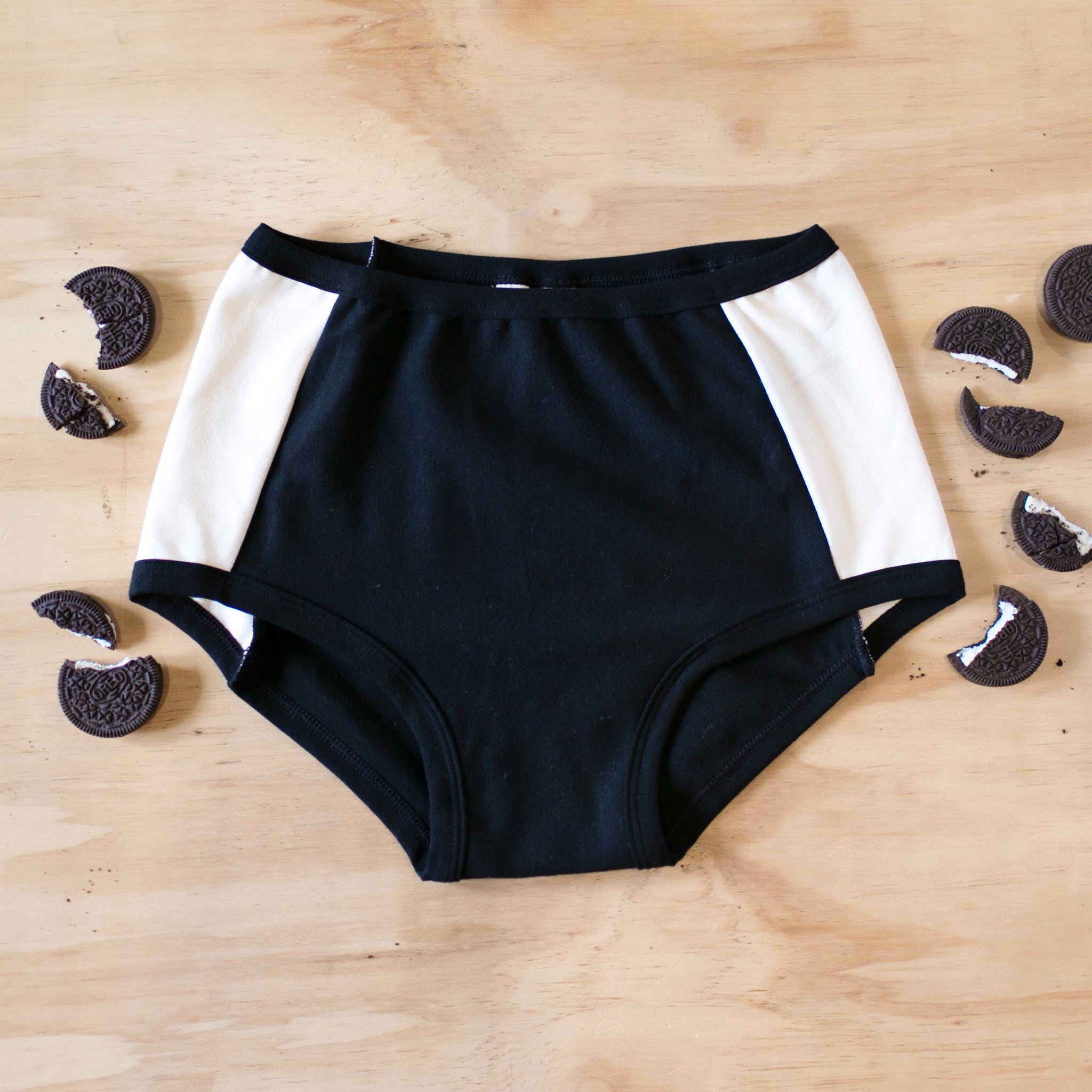 Flat lay of Thunderpants Panel Pant Original style underwear in Cookies and Cream - black center and white sides.