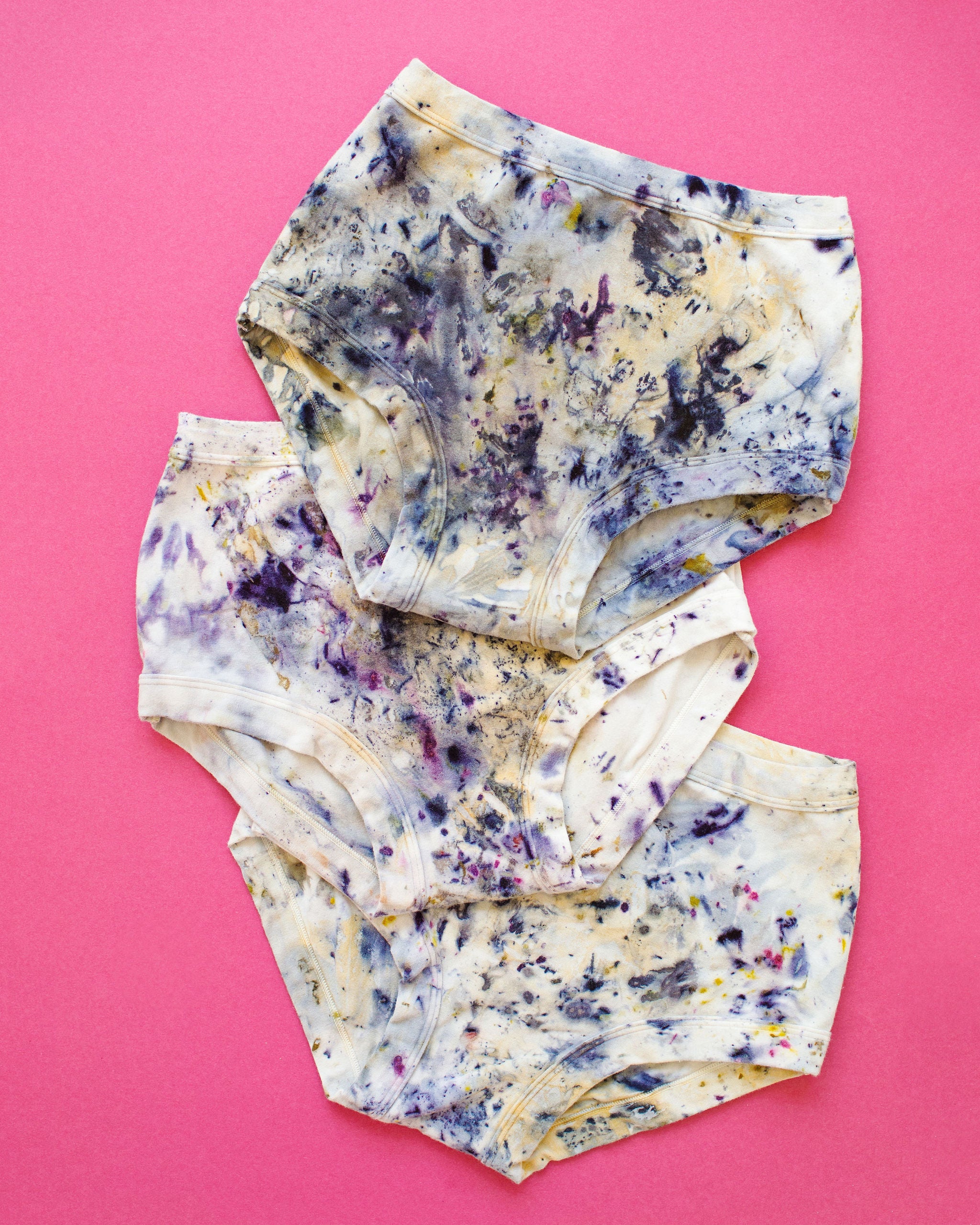 Flat lay of three Thunderpants Original style underwear in Cosmic Compost hand dye.