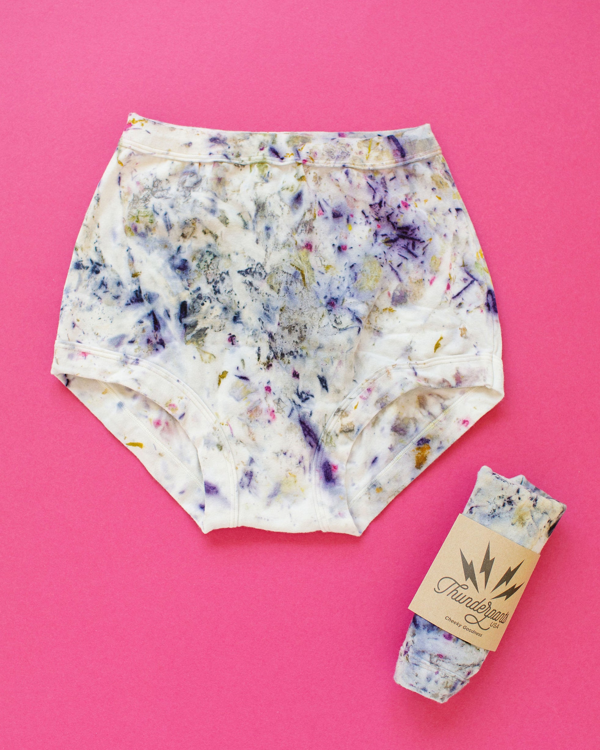 Flat lay of Thunderpants Sky Rise style underwear in Cosmic Compost hand dye.