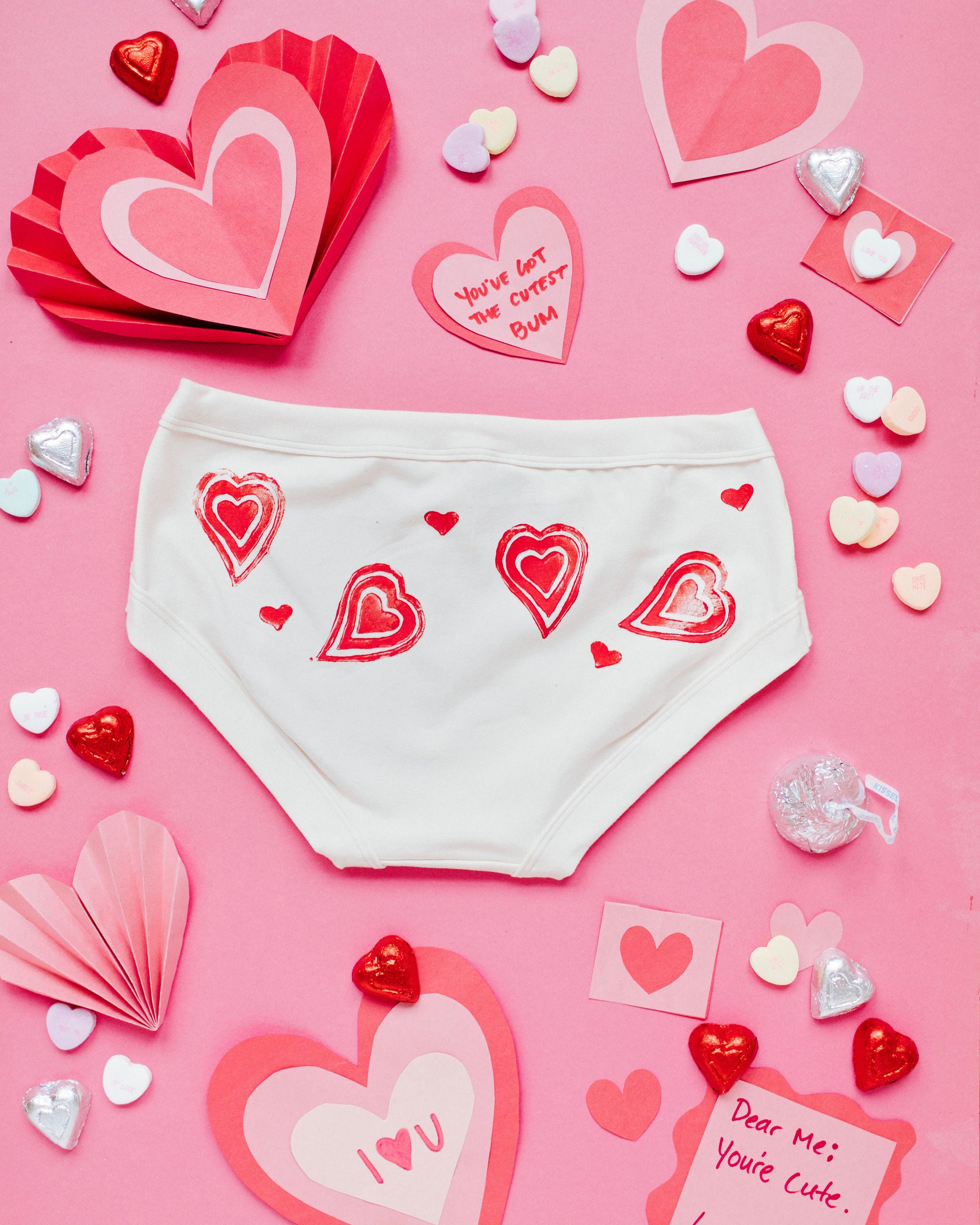 Flat lay of the back of Thunderpants Hipster style underwear with hand printed red hearts on Vanilla.