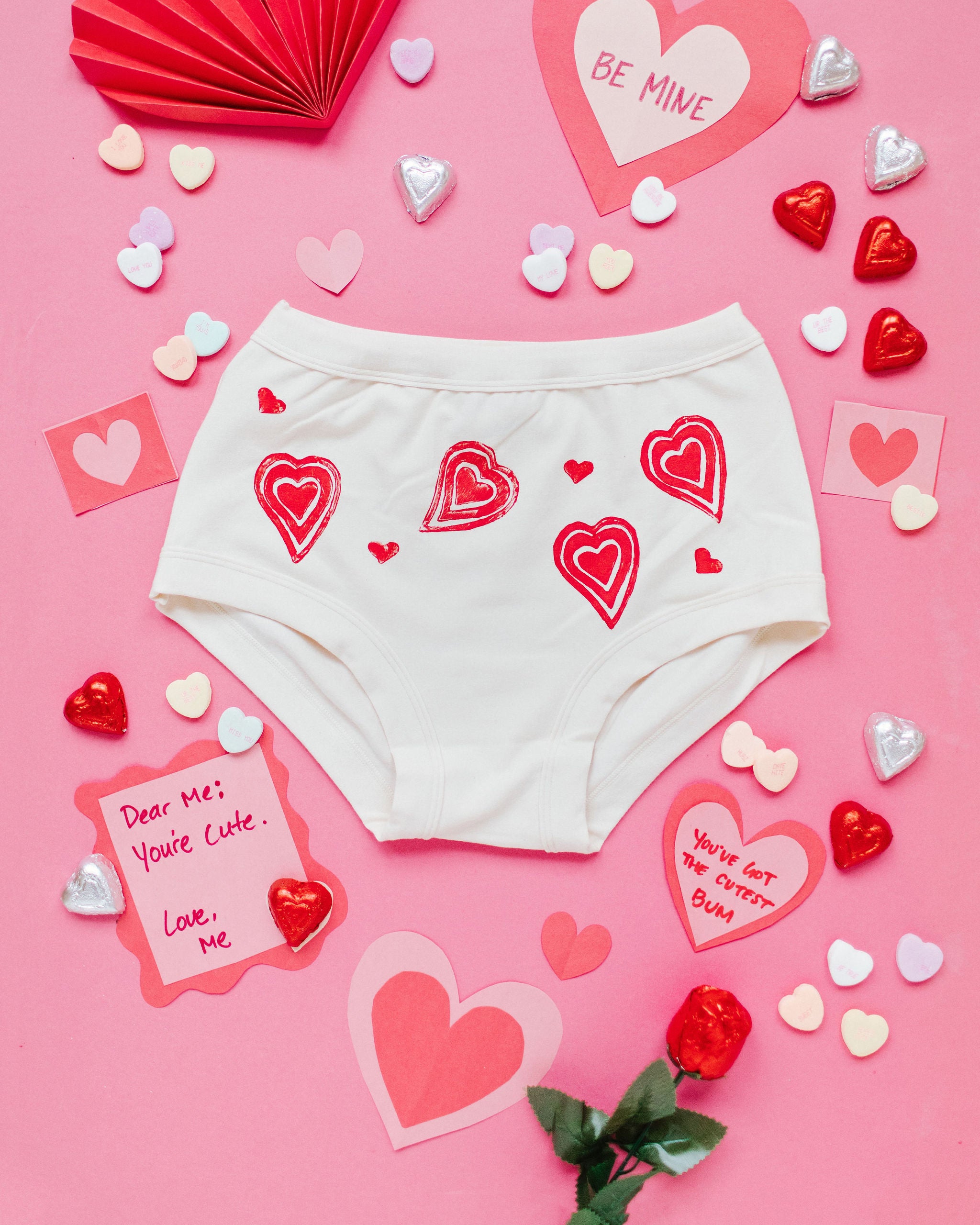 Flat lay of Thunderpants Original style underwear with hand printed red hearts on Vanilla.