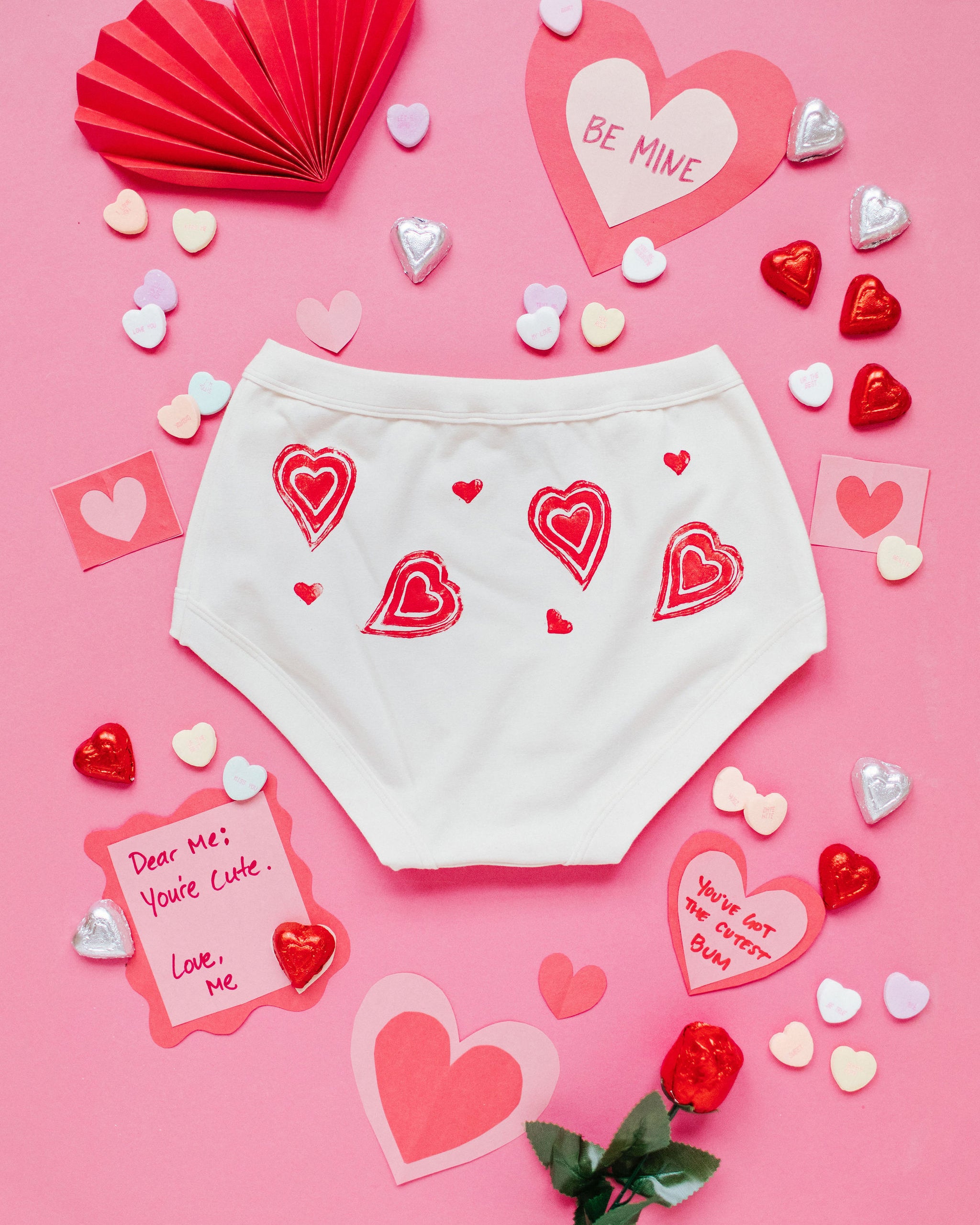 Flat lay of the back of Thunderpants Original style underwear with hand printed red hearts on Vanilla.