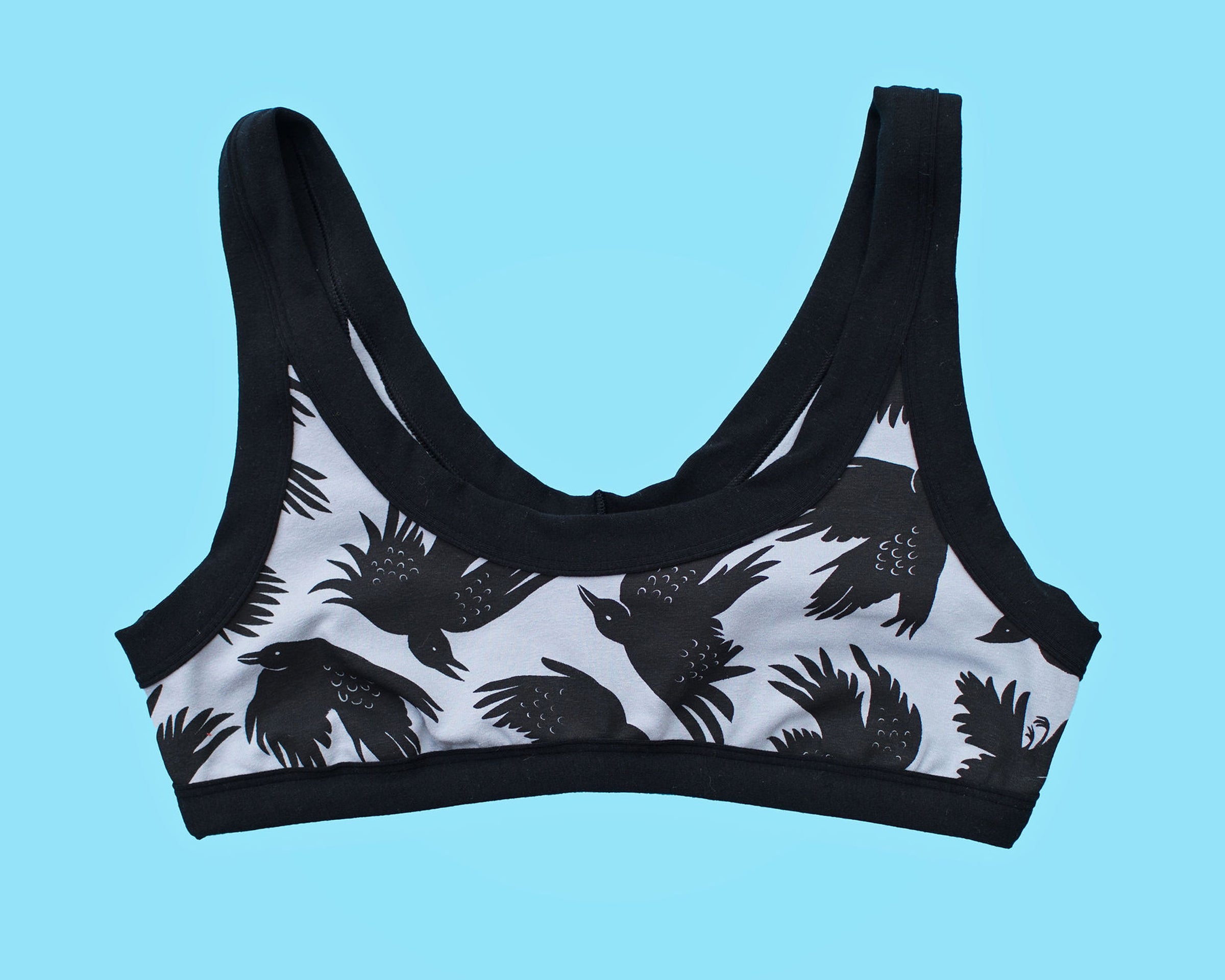 Flatlay of Thunderpants Bralette in So it Crows - black birds on grey.