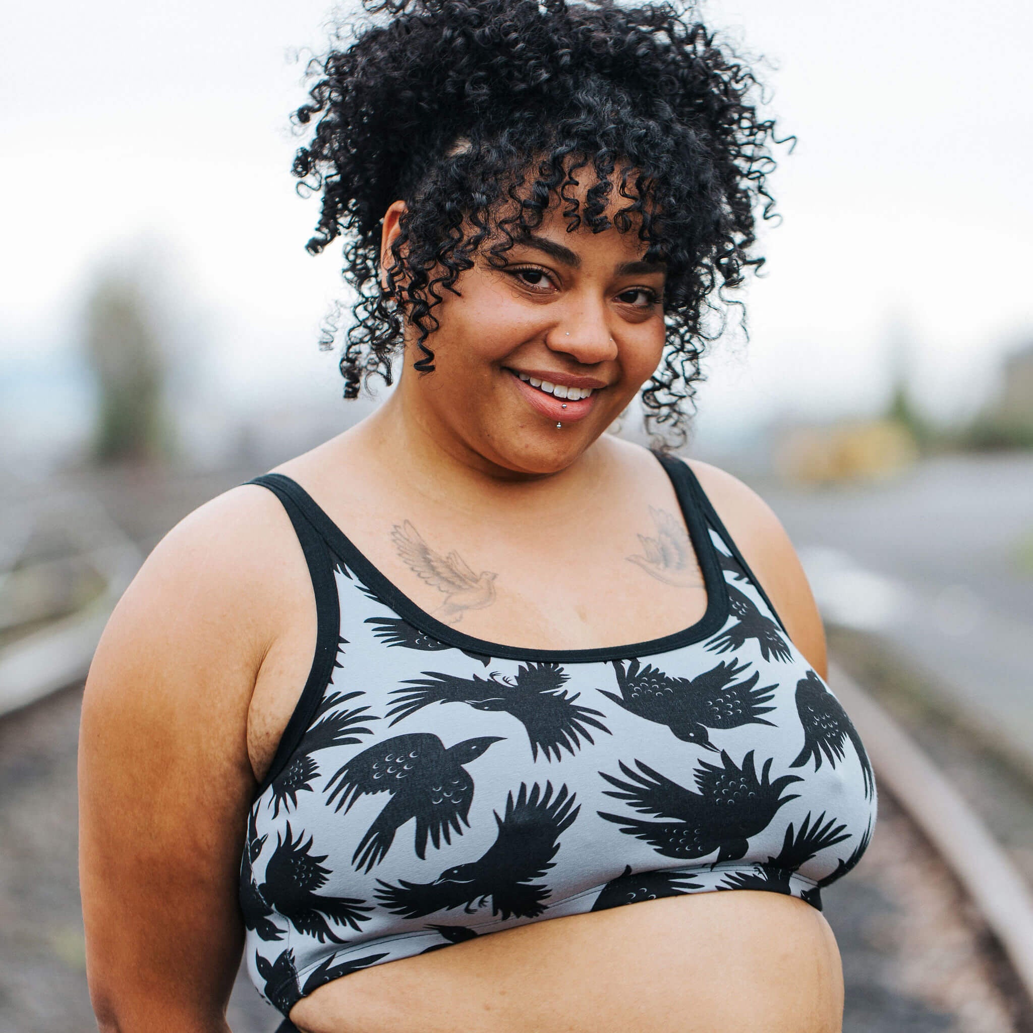 Model wearing Thunderpants Longline Bra in So it Crows - black crows on grey.