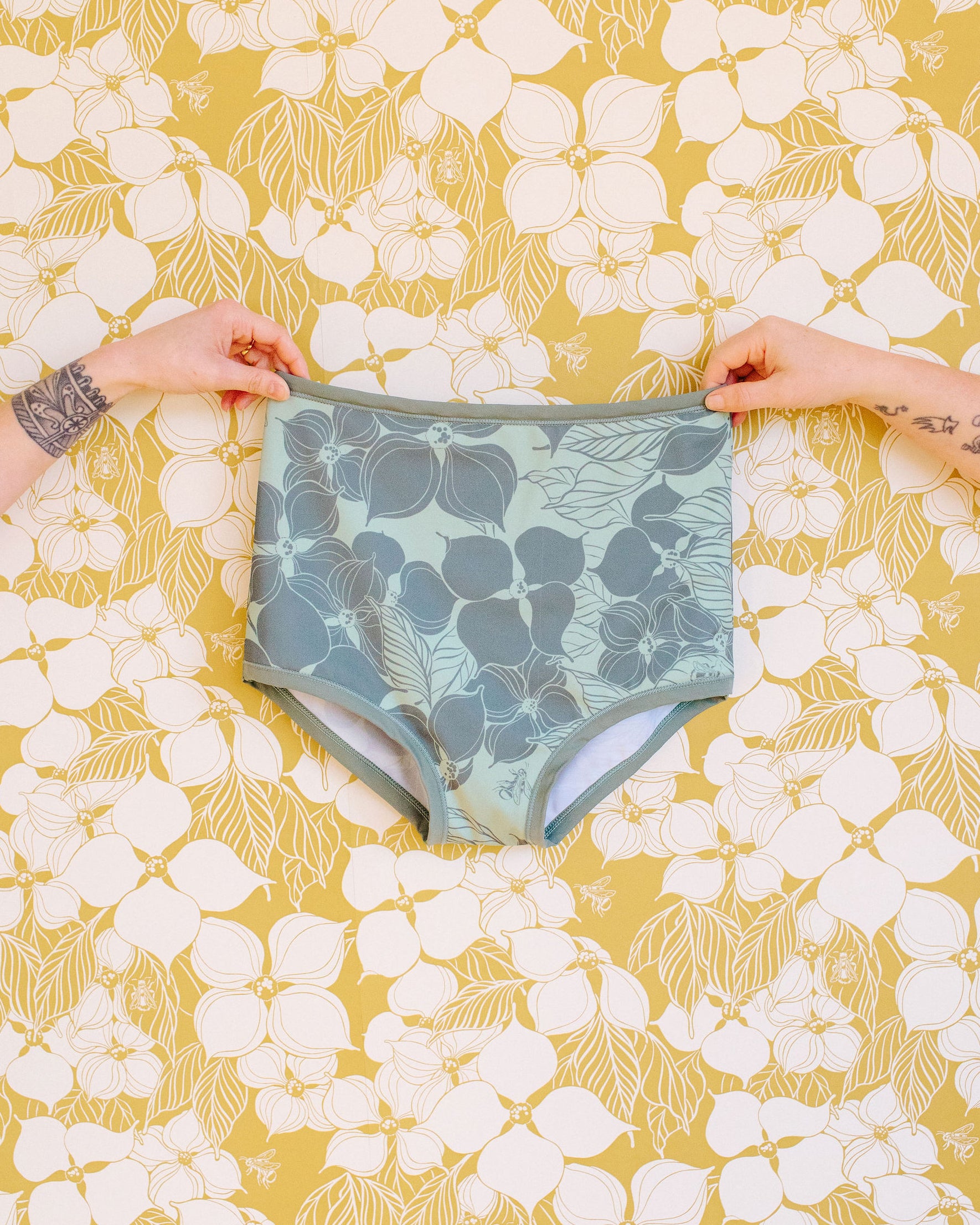 Hands holding Thunderpants Sky Rise Swimwear Bottom in Dogwood by Lonesome Pictopia.