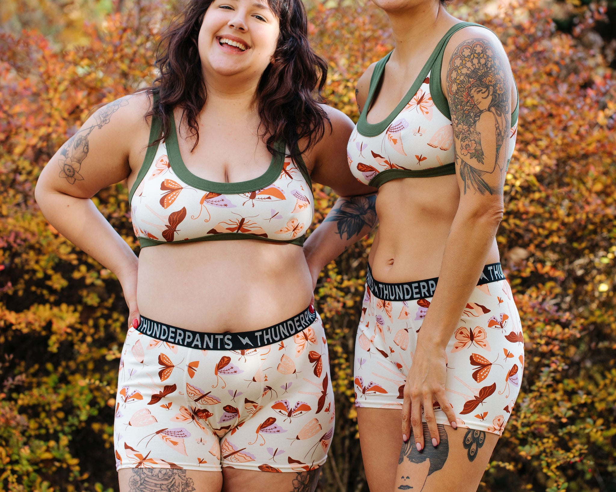 Two models wearing Thunderpants Boxer Brief style underwear and Bralettes n Field Day: a moth print in red, orange, pink, and purple.