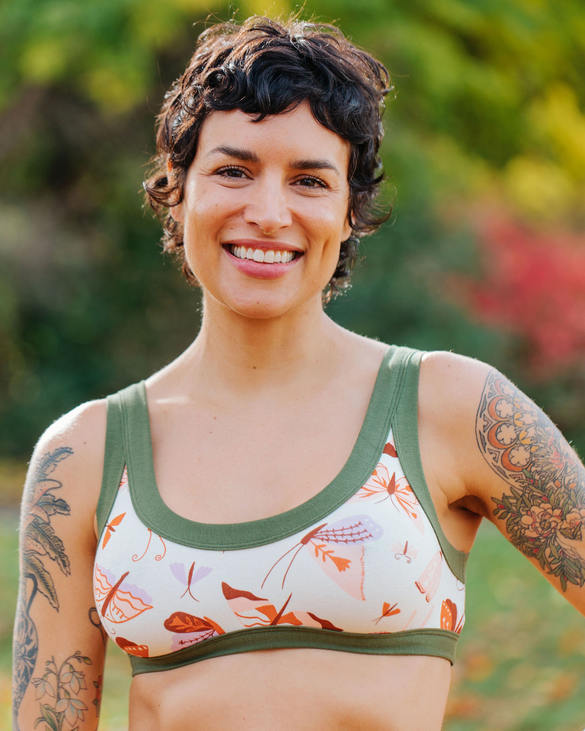 Model wearing Thunderpants a Bralette in Field Study: a moth print in red, orange, pink, and purple bound in green.