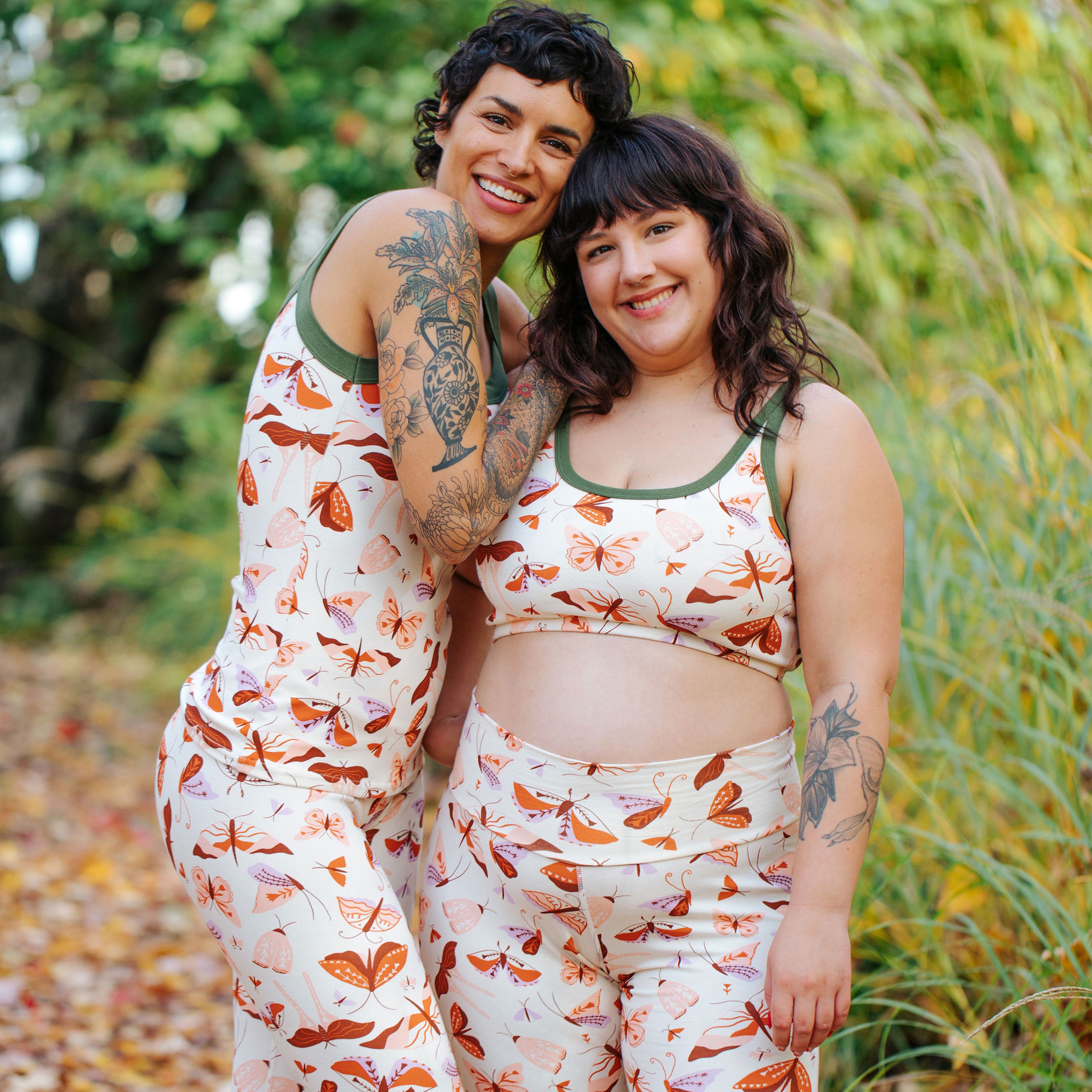 Two models wearing various Thunderpants items in Field Study: a moth print with red, pink, purple and green binding.