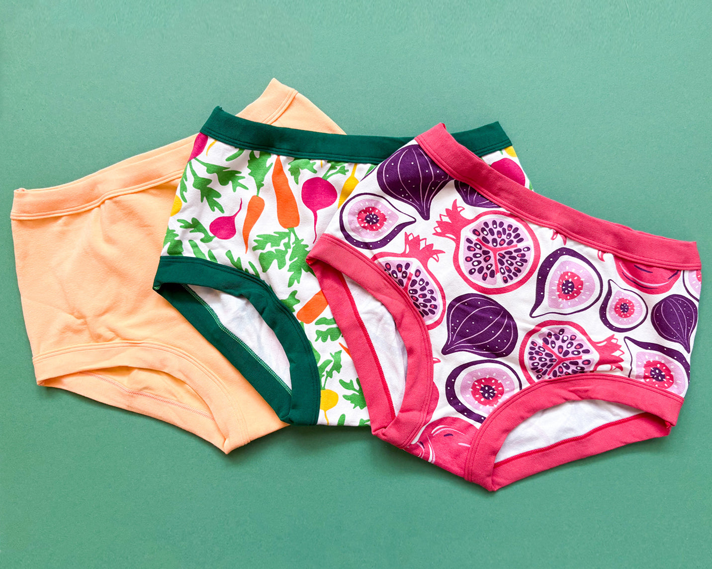 Flat lay of Thunderpants Original style underwear in Orange Sherbet, Two Fruits, and Root Veggies.