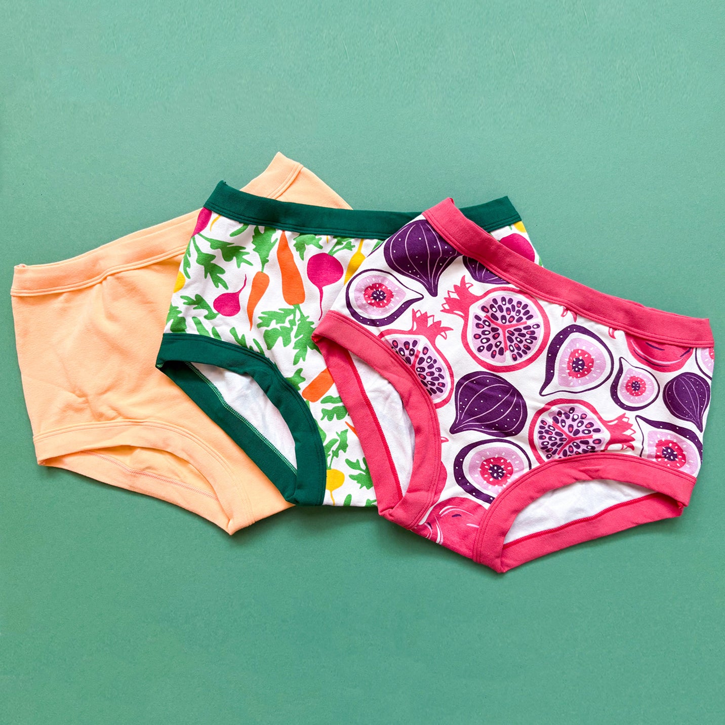 Flat lay of three Thunderpants Original style underwear in Two Fruits, Root Veggies, and Orange Sherbet.