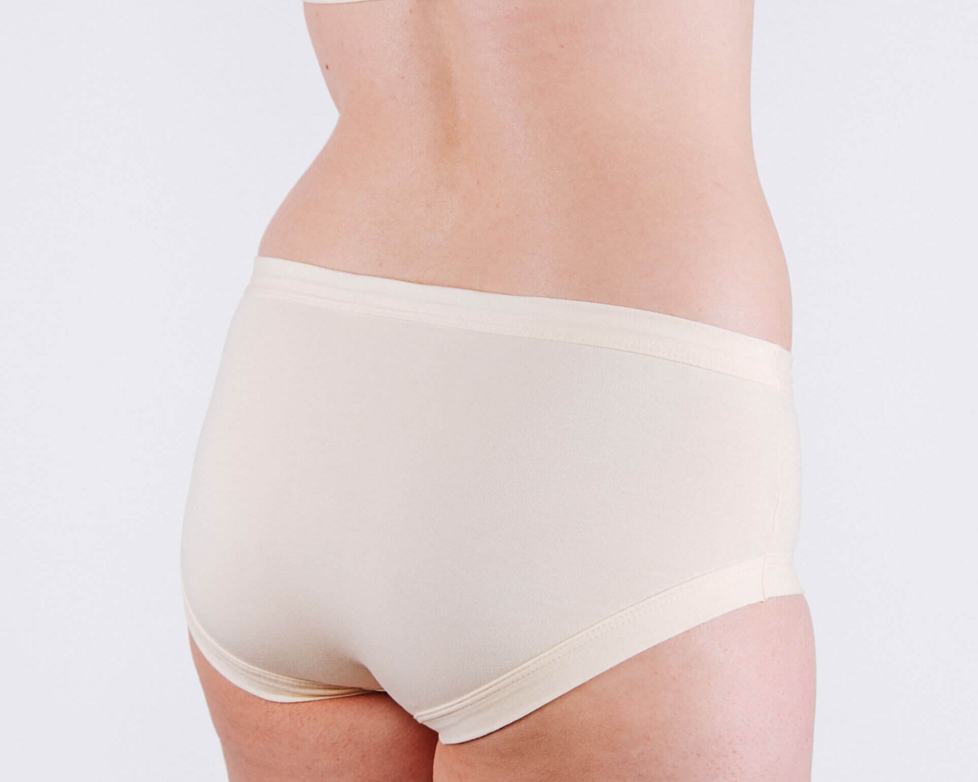 Fit photo from the back of Thunderpants organic cotton Hipster style underwear in off-white vanilla, showing a wedgie-free bum, on a model.