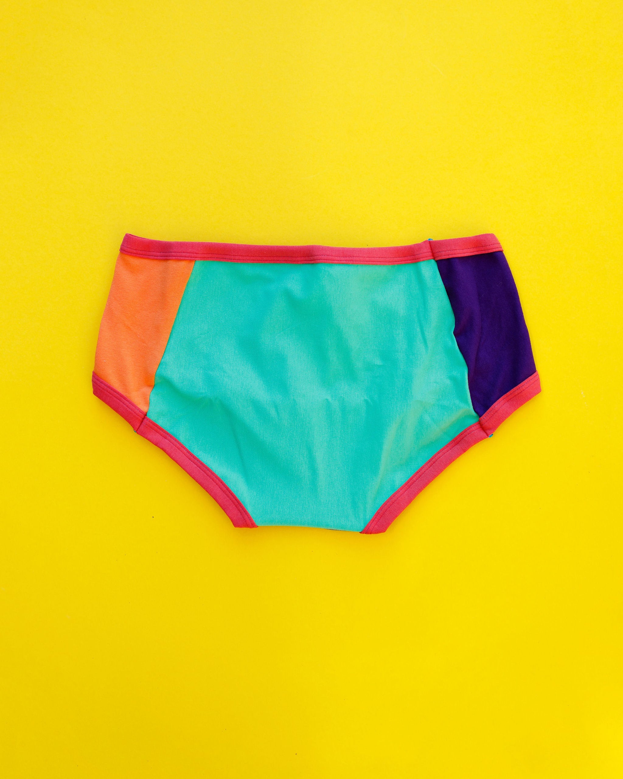 Flat lay of Thunderpants Panel Pants Hipster style underwear in Color Block Scraps - various solid colors.
