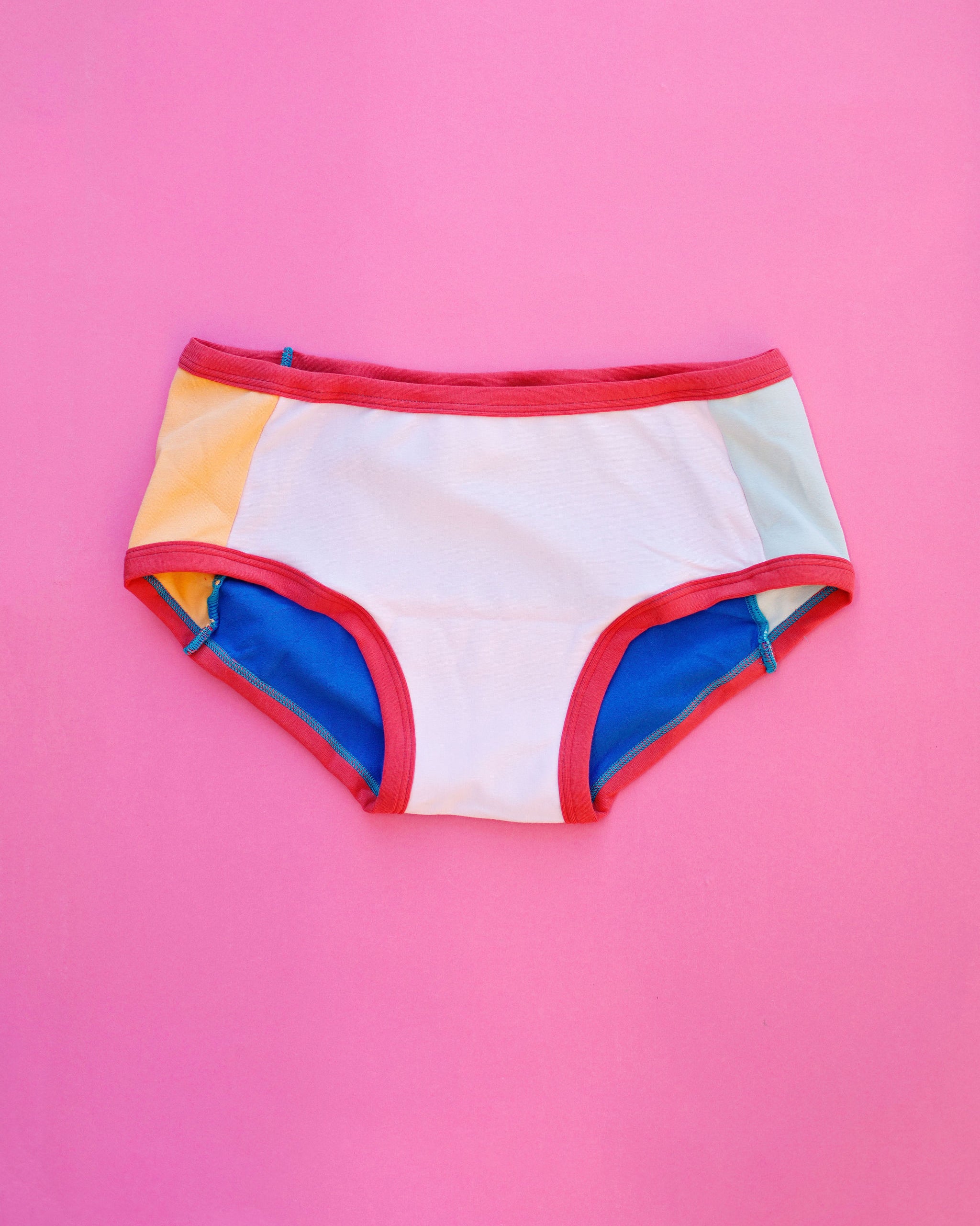 Flat lay of Thunderpants Panel Pants Hipster style underwear in Color Block Scraps - various solid colors.