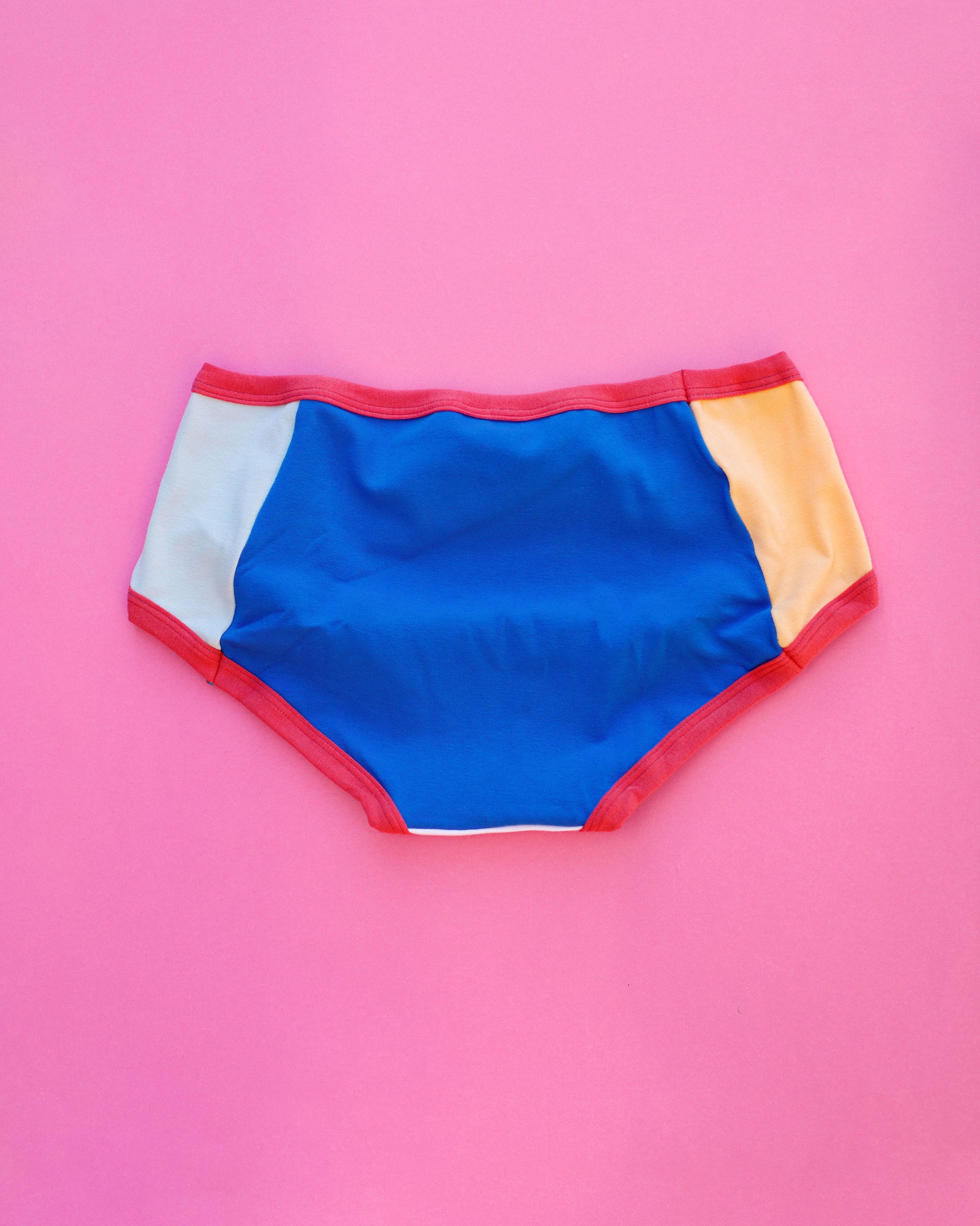 Flat lay of Thunderpants Panel Pants Hipster style underwear in Color Block Scraps - various solid colors.