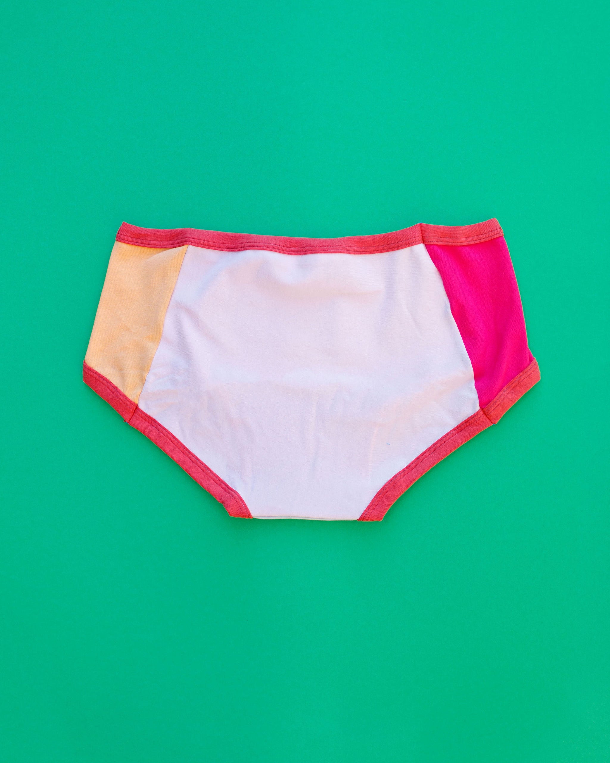 Flat lay of Thunderpants Panel Pants Hipster style underwear in Color Block Scraps - various solid colors.
