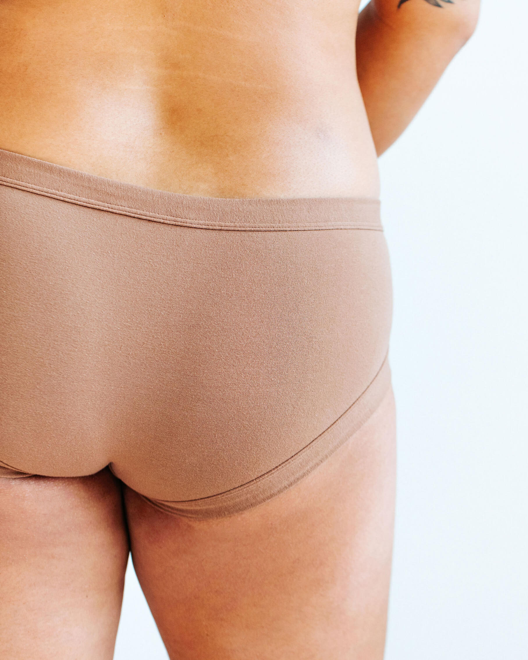 Close up of model wearing Thunderpants Hipster style underwear and Bralette in Hazelnut color.