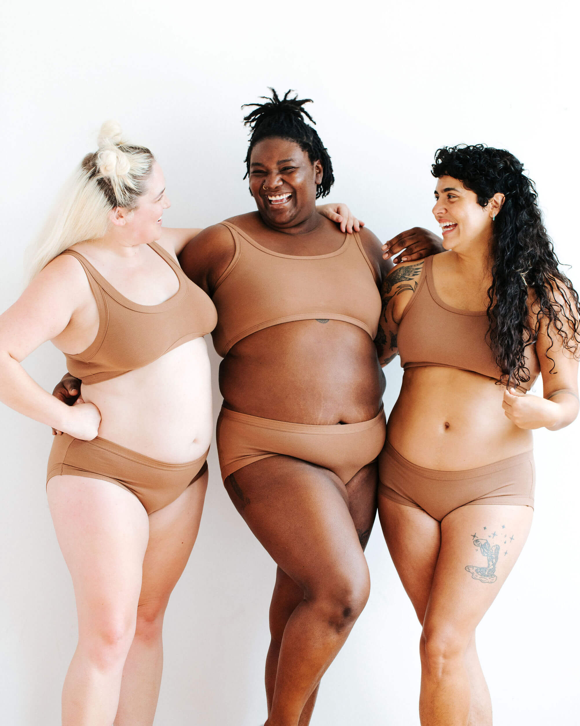 Three models wearing Thunderpants Hipster style underwear and Longline Bra in Hazelnut color.