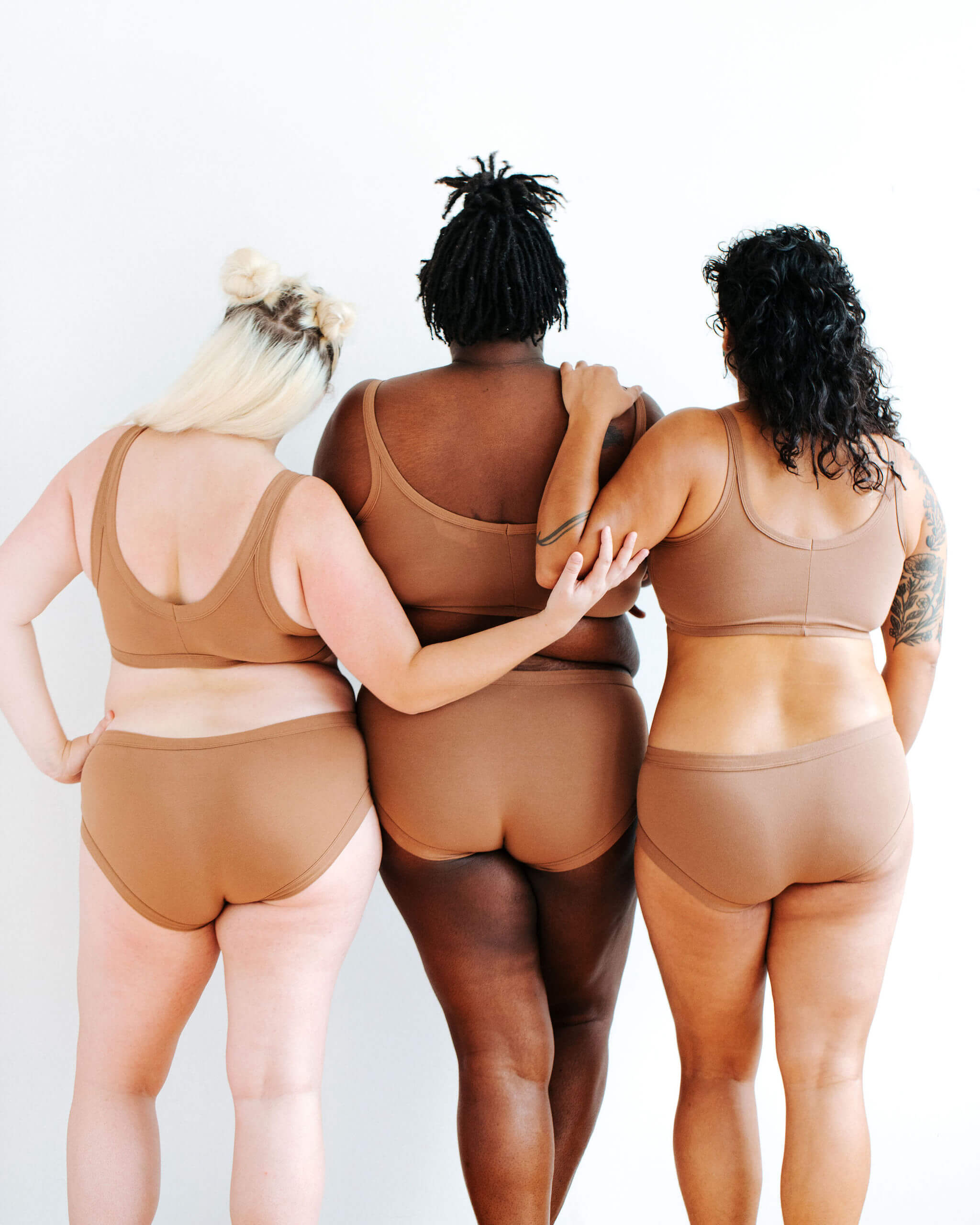 Three models wearing Thunderpants Hipster style underwear and Longline Bra in Hazelnut color.