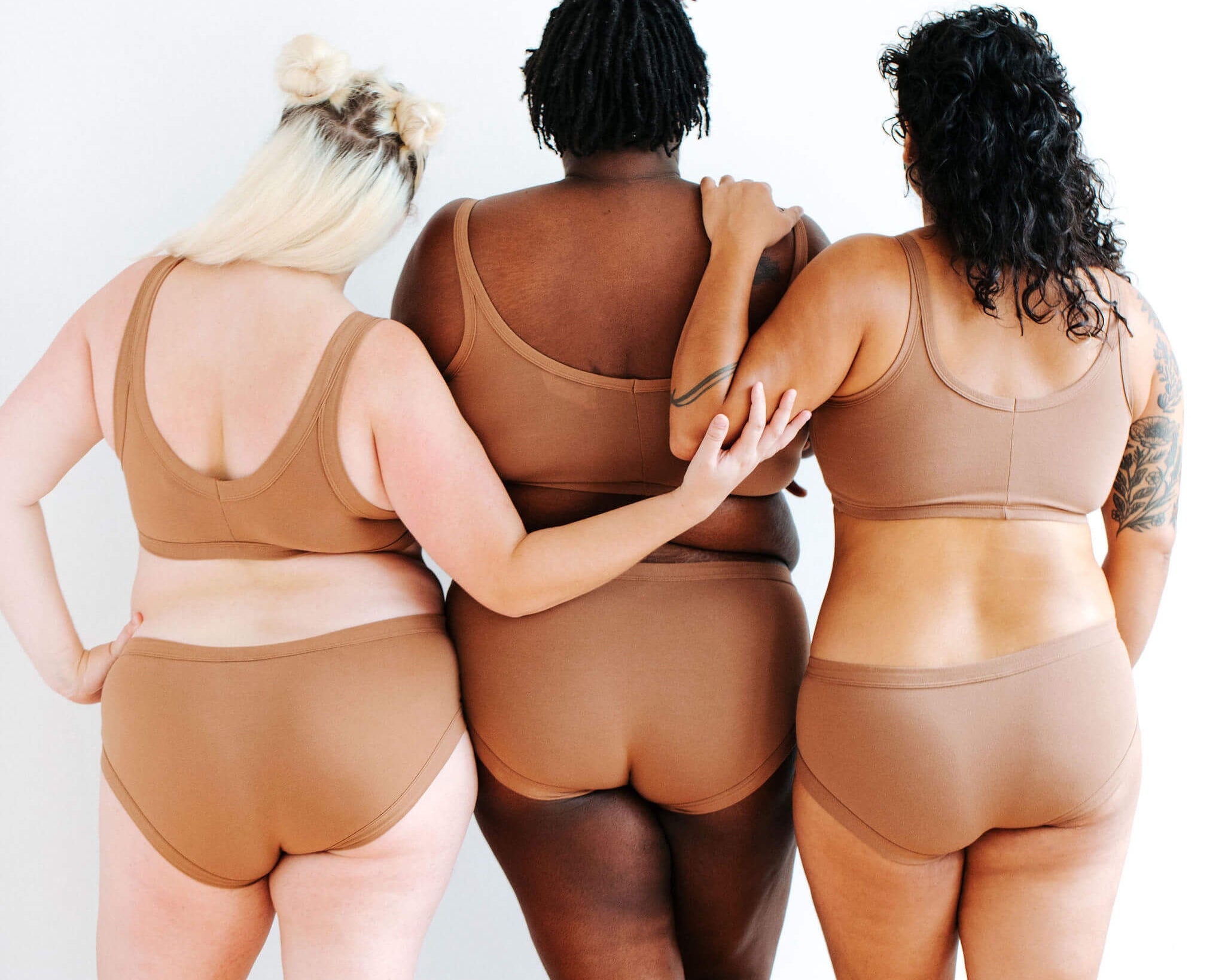 Three models wearing Thunderpants Hipster style underwear and Longline Bra in Hazelnut color.