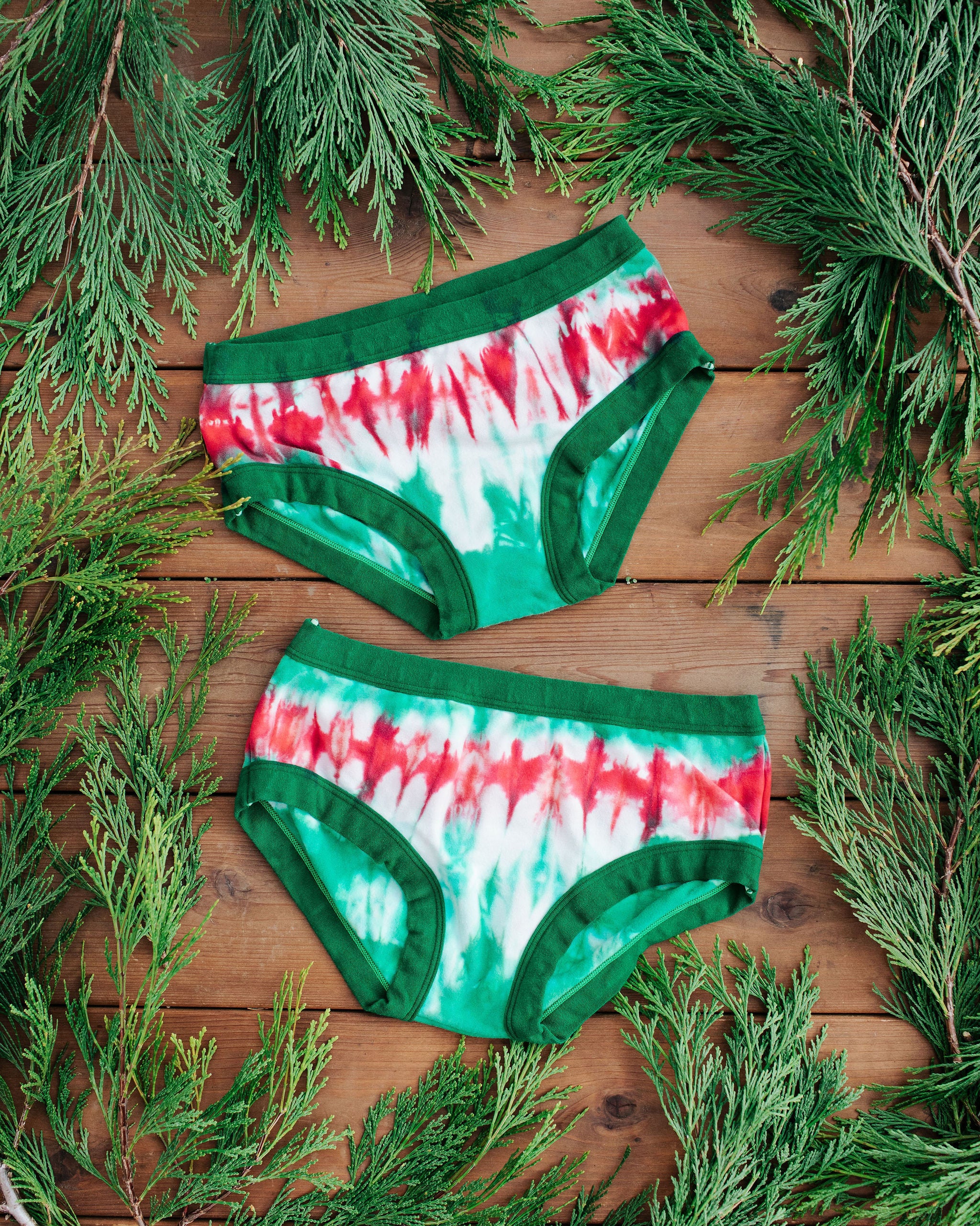 Flat lay of two Thunderpants Hipster style underwear in Holiday Dye - red and green tie dye with green binding. 