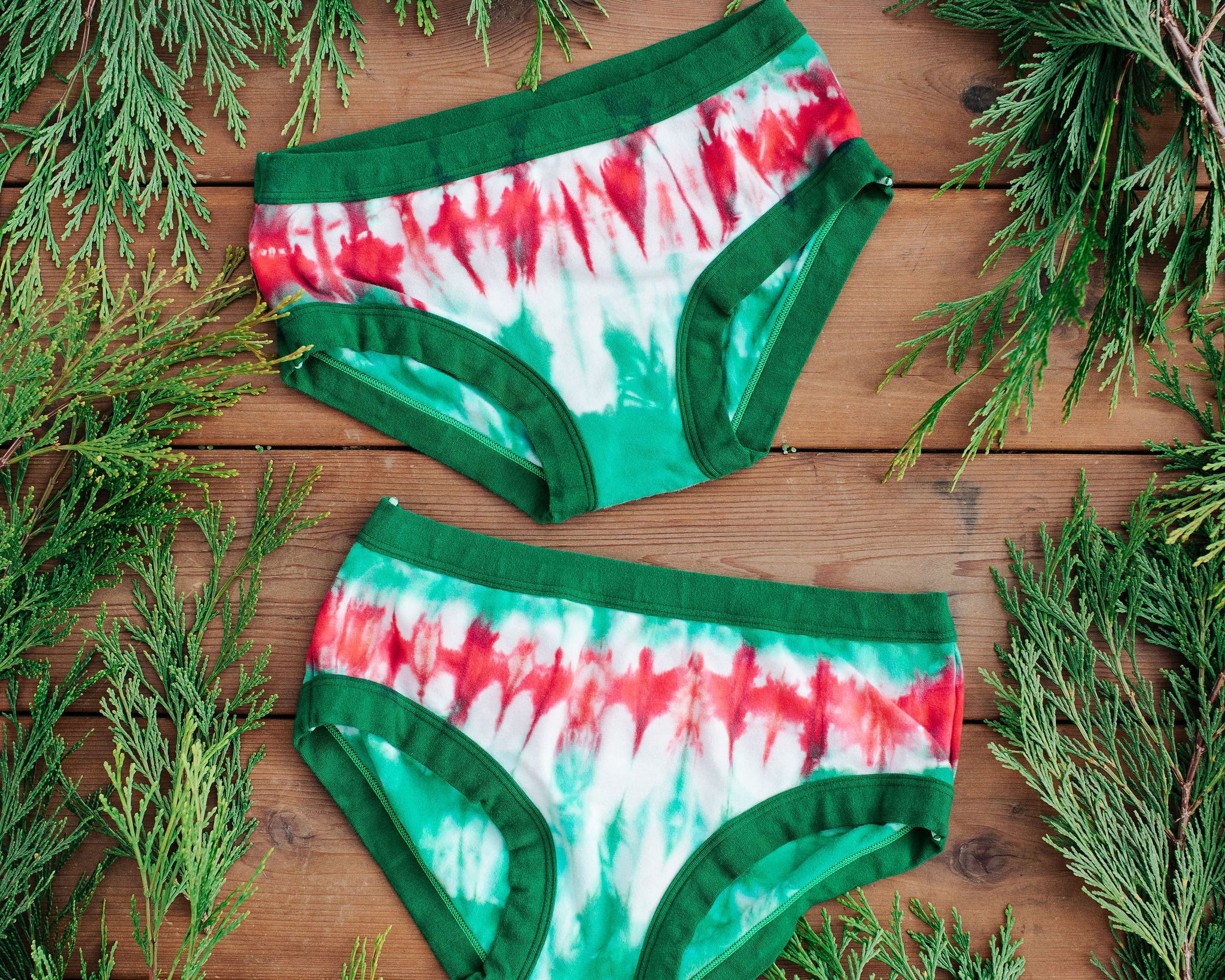 Flat lay of two Thunderpants Hipster style underwear in Holiday Dye - red and green tie dye with green binding. 