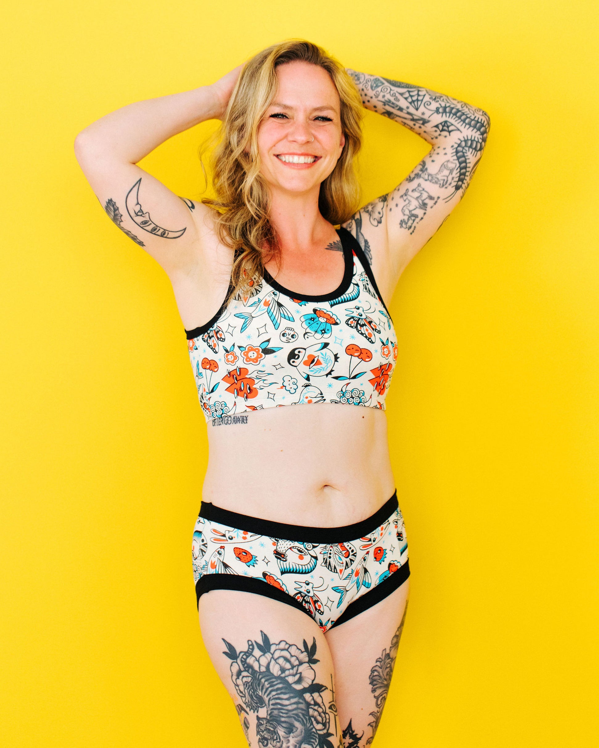 Model wearing Thunderpants Hipster style underwear and Longline Bra in Inked Up - a tattoo pattern with black, red, and blue. 