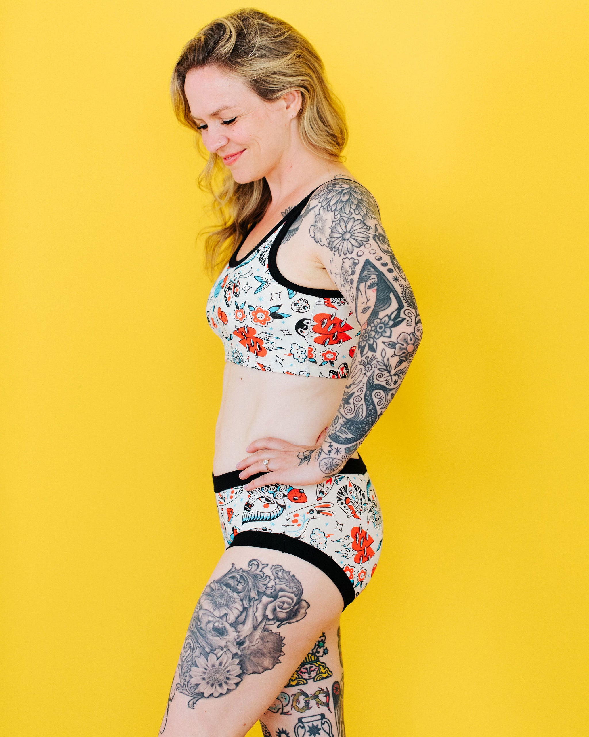 Model wearing Thunderpants Hipster style underwear and Longline Bra in Inked Up - a tattoo pattern with black, red, and blue. 