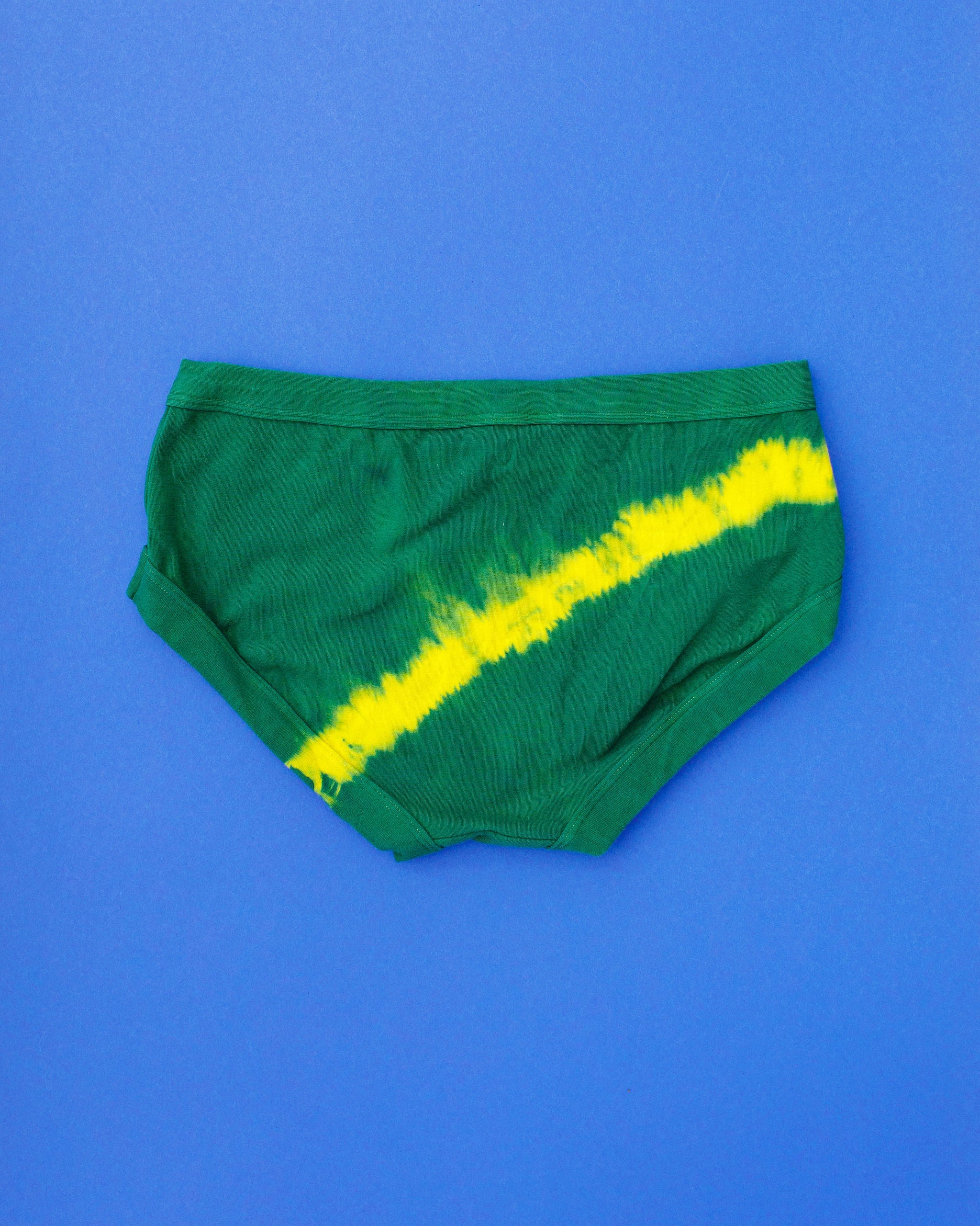 Flat lay of Thunderpants Hipster style underwear in Lightning Bolt hand dye - blue/green with yellow stripe.