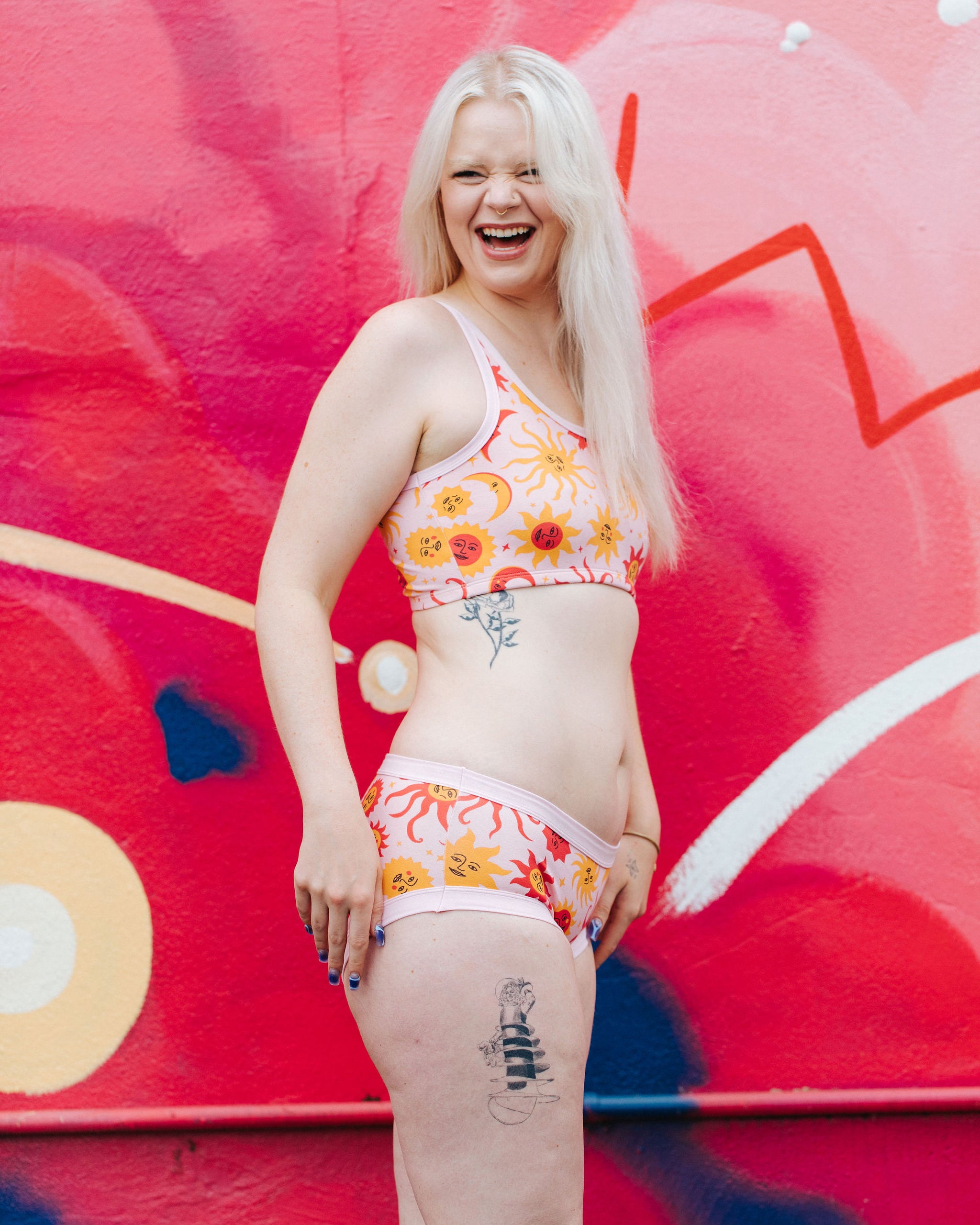 Model wearing Thunderpants Hipster style underwear and Longline Bra in Luna y Sol print - pink, yellow, and orange suns and moons.