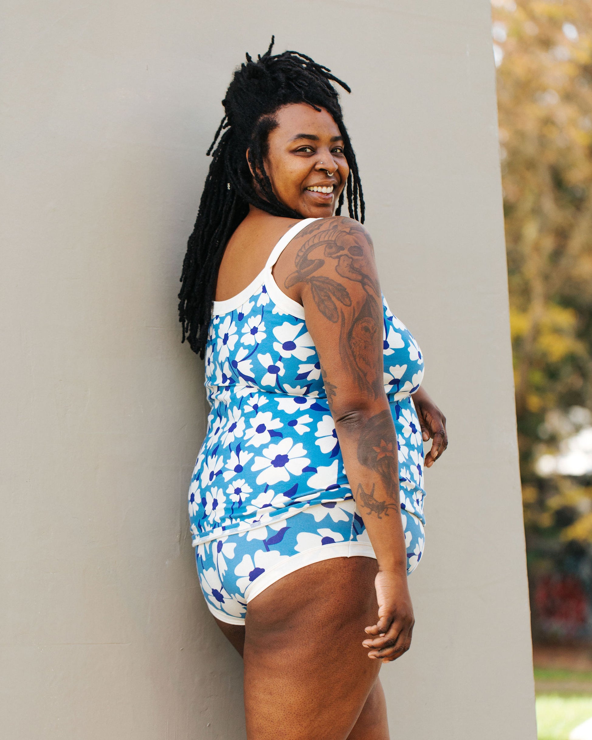 Model of Thunderpants Hipster style underwear and Camisole in Moody Blooms - white and blue flowers with blue background.