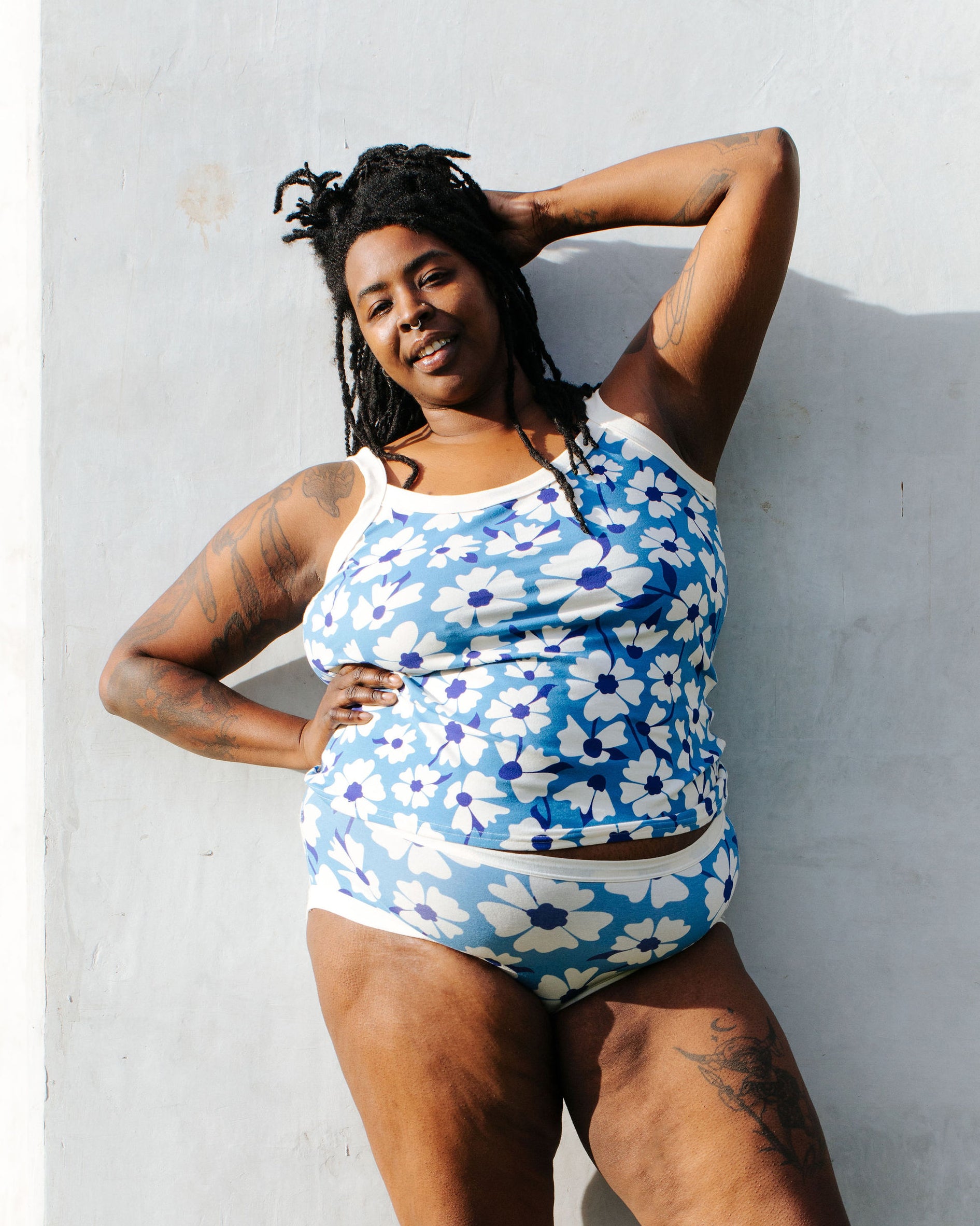 Model of Thunderpants Hipster style underwear and Camisole in Moody Blooms - white and blue flowers with blue background.