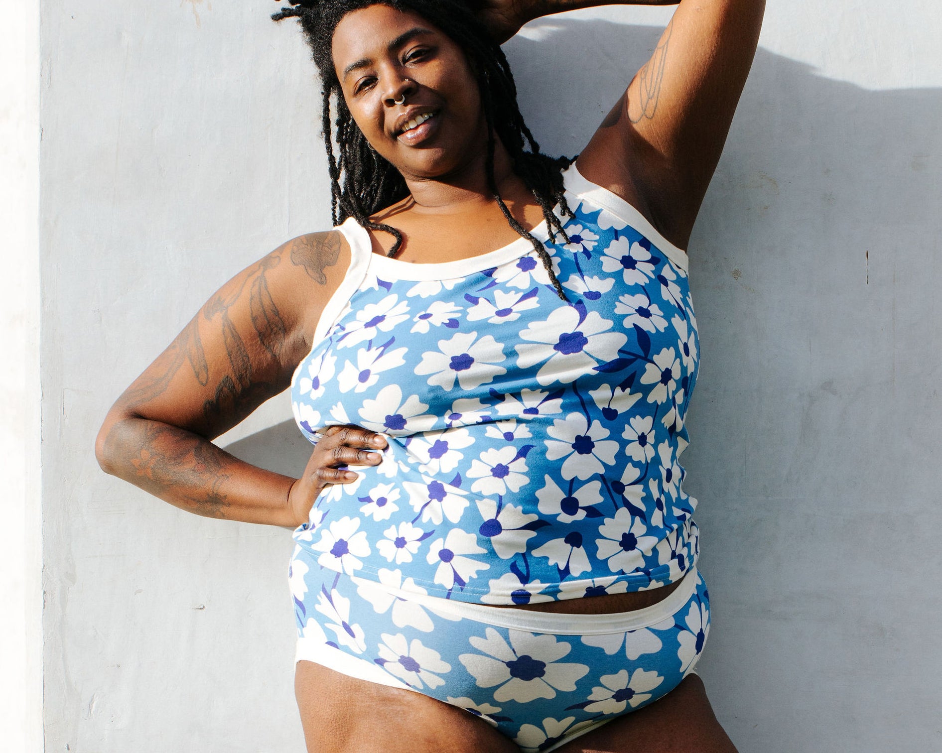 Model of Thunderpants Hipster style underwear and Camisole in Moody Blooms - white and blue flowers with blue background.