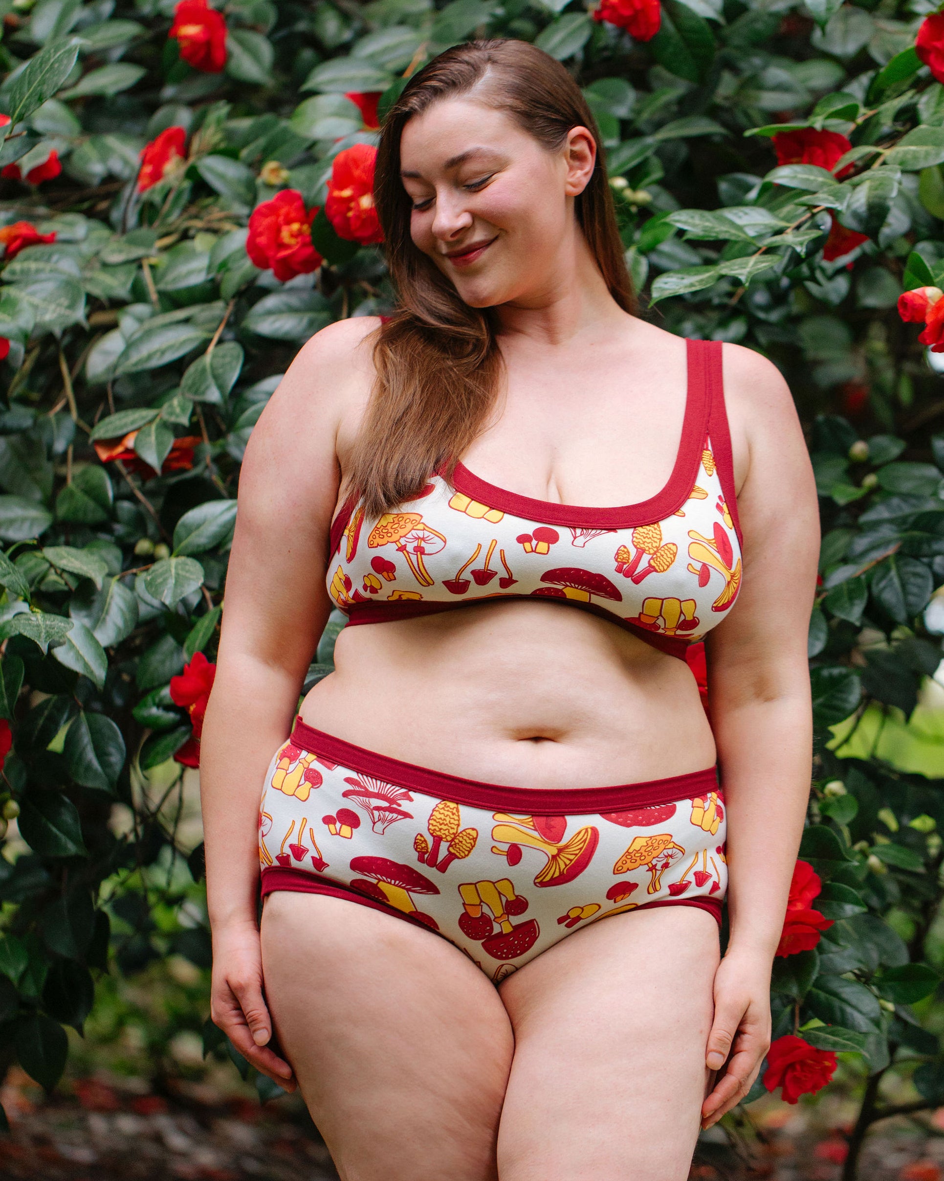 Model wearing Thunderpants Hipster style underwear and Bralette in Whadda Mushroom - red, yellow, and orange mushrooms.