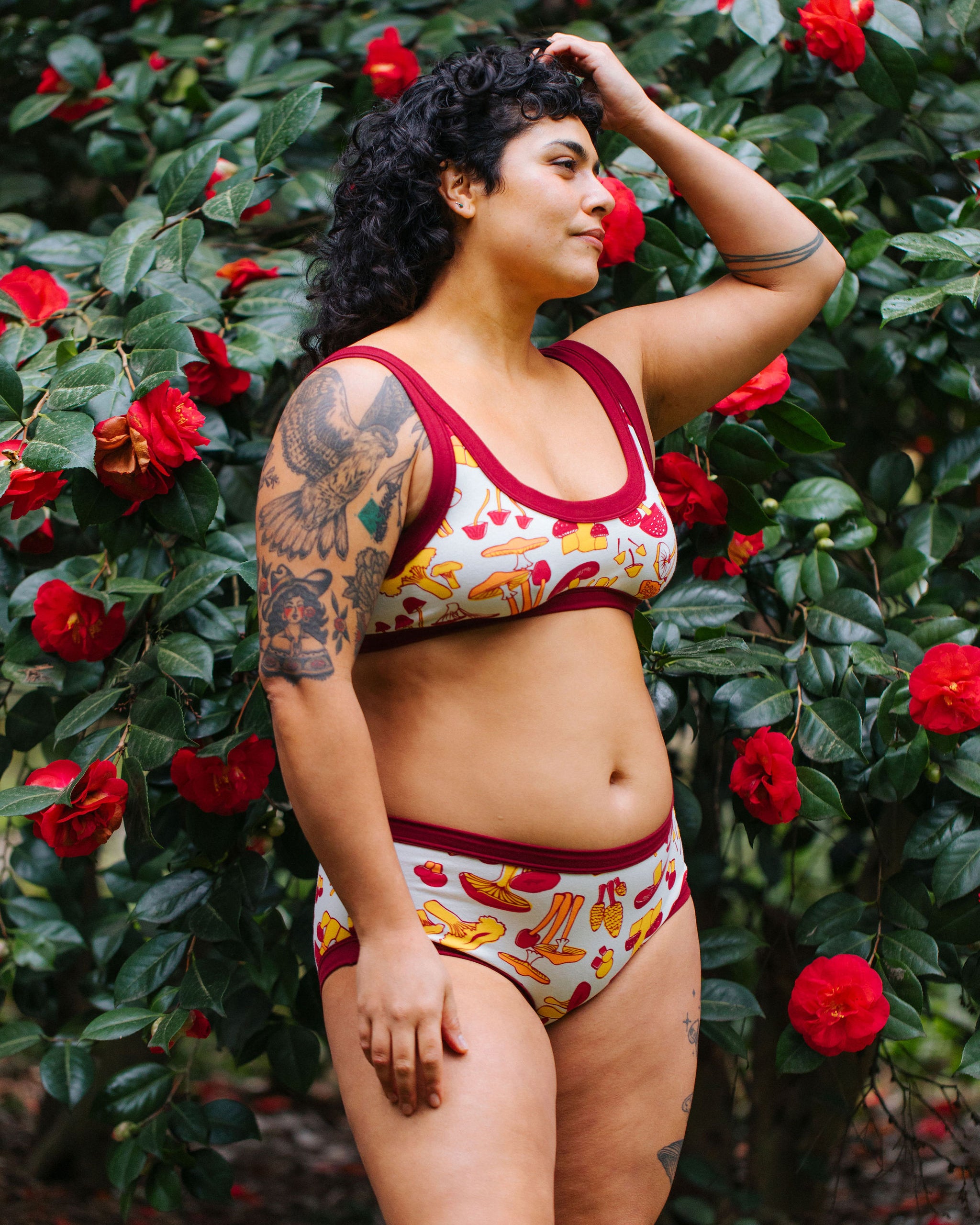 Model wearing Thunderpants Hipster style underwear and Bralette in Whadda Mushroom - red, yellow, and orange mushrooms.