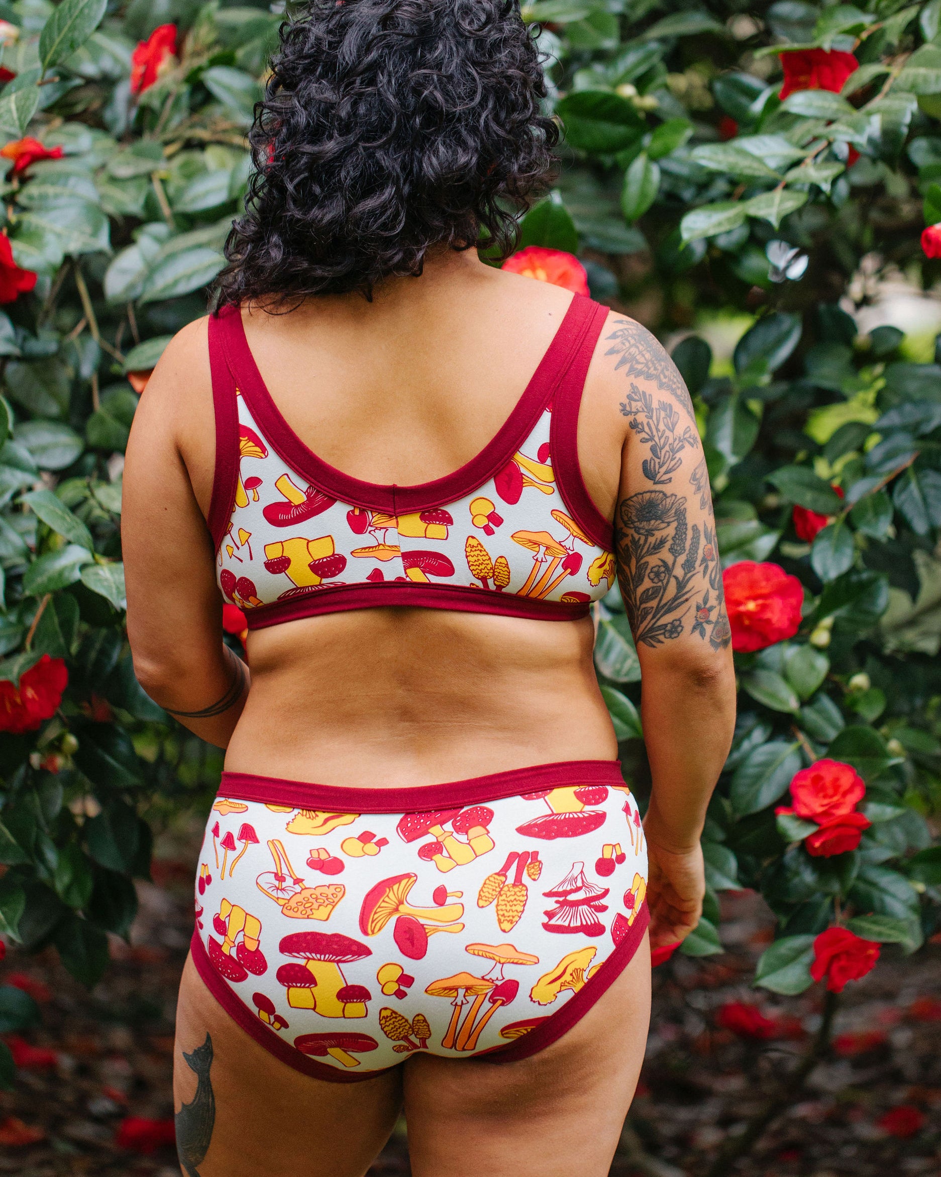 Model wearing Thunderpants Hipster style underwear and Bralette in Whadda Mushroom - red, yellow, and orange mushrooms.